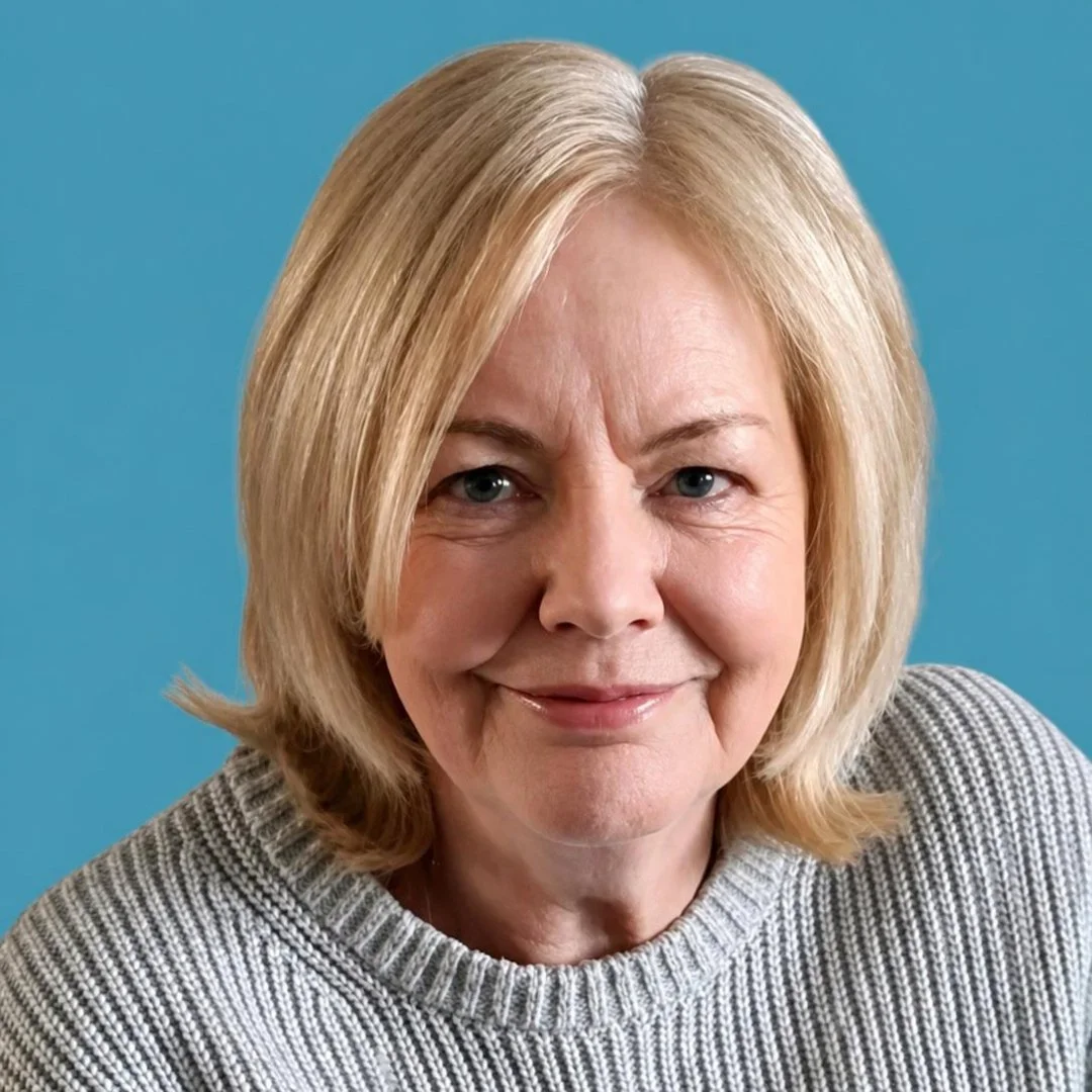 Close-up of a middle-aged woman with blonde hair wearing a gray sweater against a blue background.