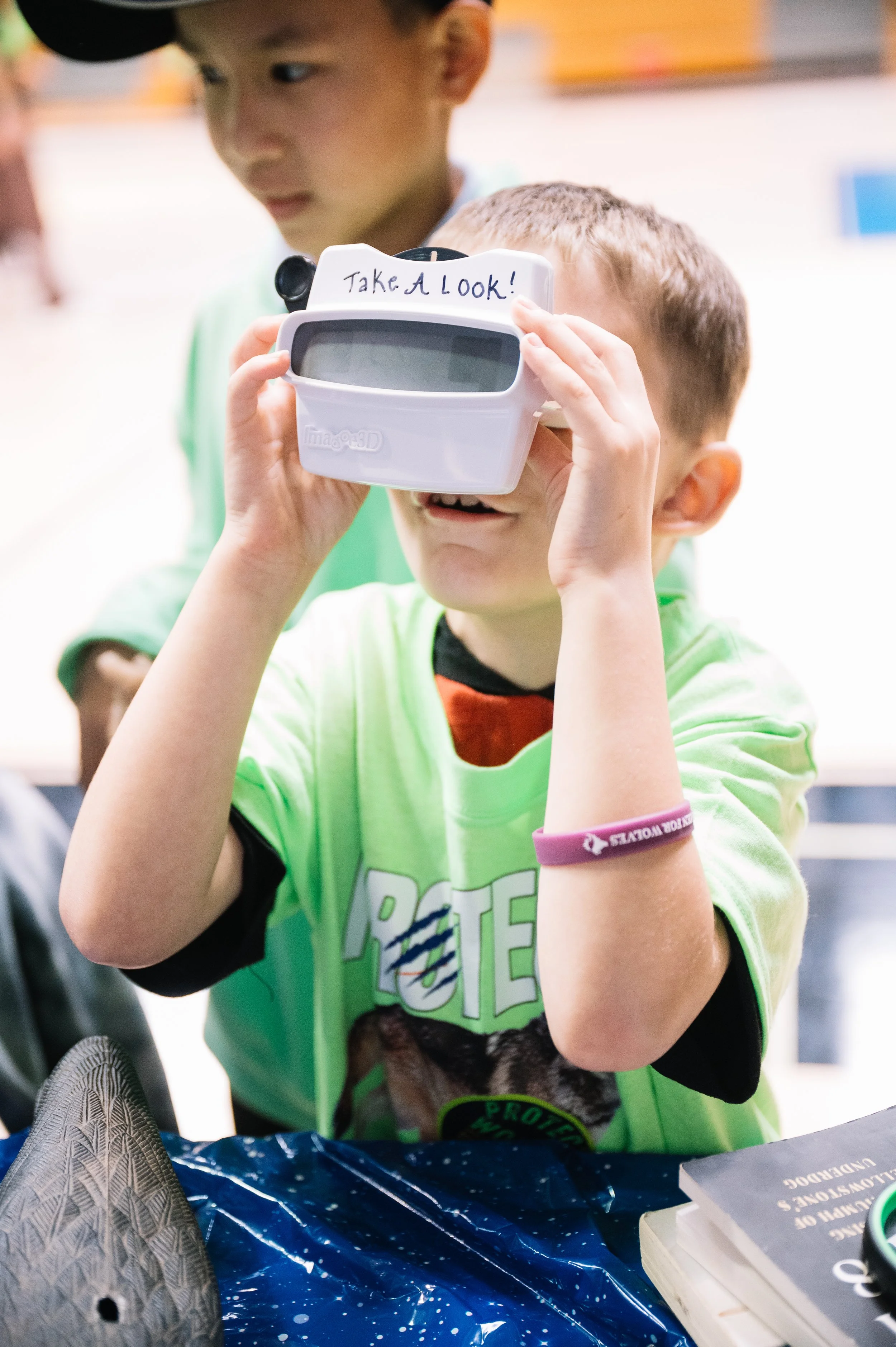 Women for Wolves event by Elsewhere — child using a VR wildlife headset