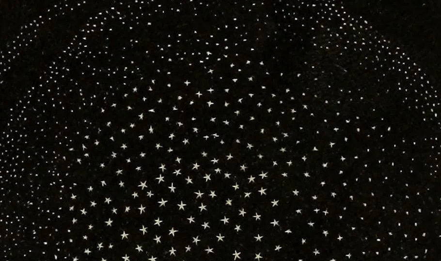 Ceiling decorated with numerous small star-shaped lights creating a starry night effect.