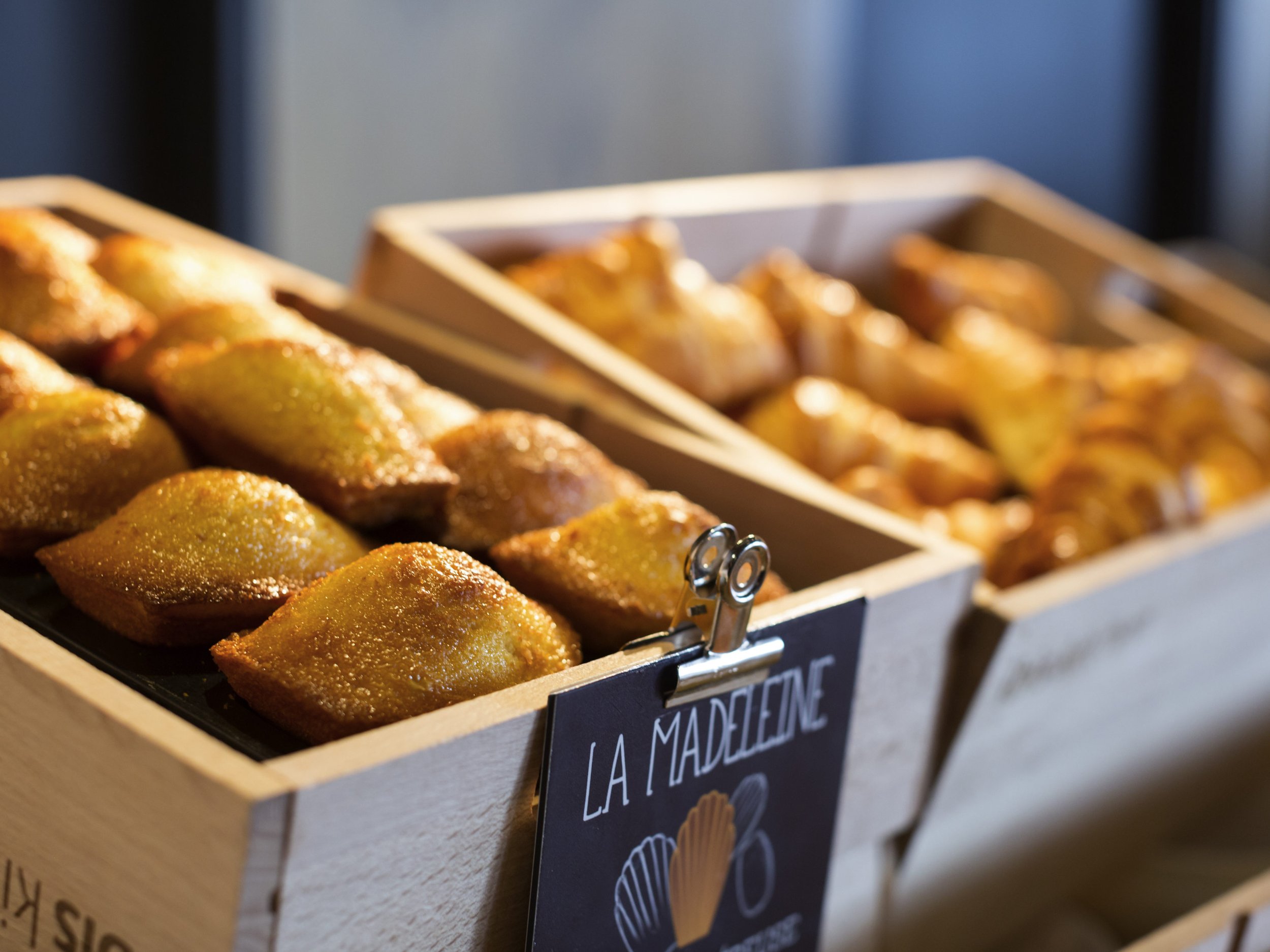 Wooden display boxes filled with golden-brown, fried pastries.