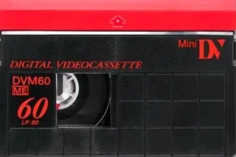 Vintage red and black Mini DV digital videocassette with label indicating Model DVM60 ME, 60 minutes playback, and 90-minute recording capability. Filmed on tape VHS. Wedding 90s
