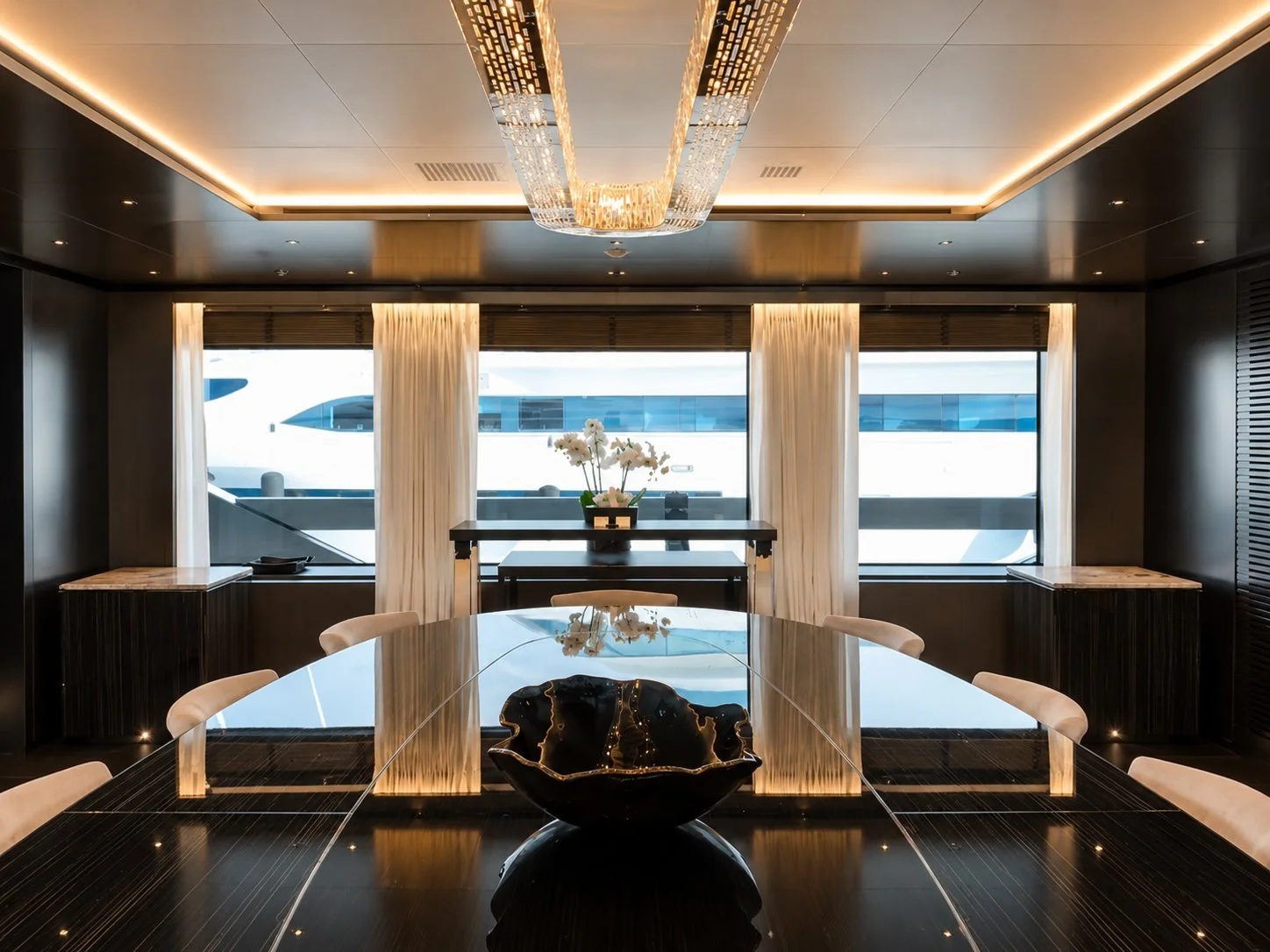 Formal dining. Lighting, window treatments, furniture — each element chosen for the room's formality.