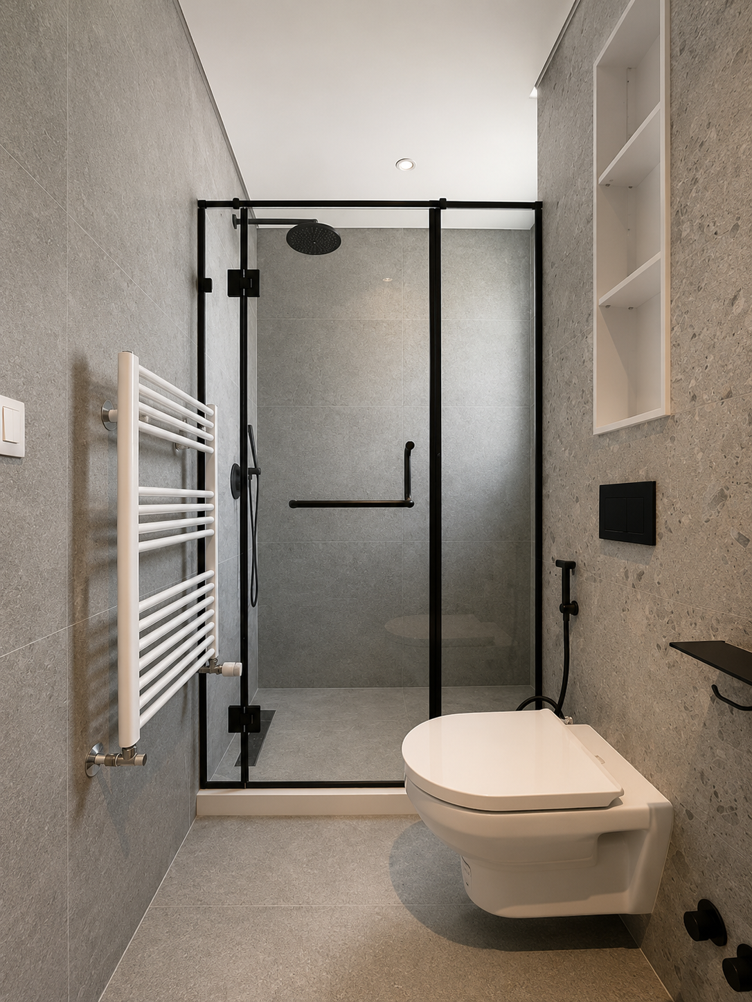 Modern bathroom with a walk-in shower with black framing, a wall-mounted toilet, a white radiator towel warmer, and textured gray wall tiles.
