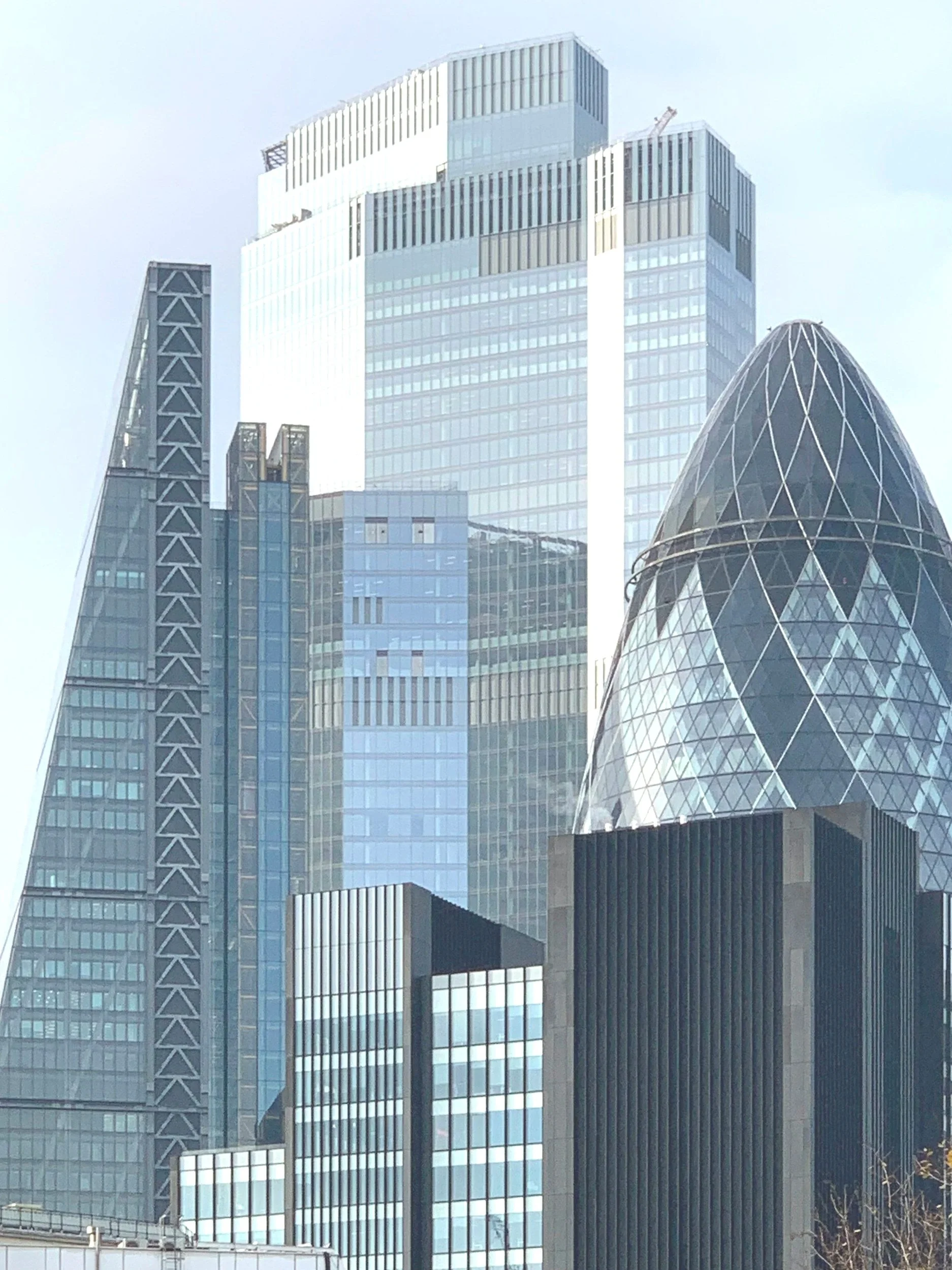 Tall, modern skyscrapers with glass facades in a cityscape.
