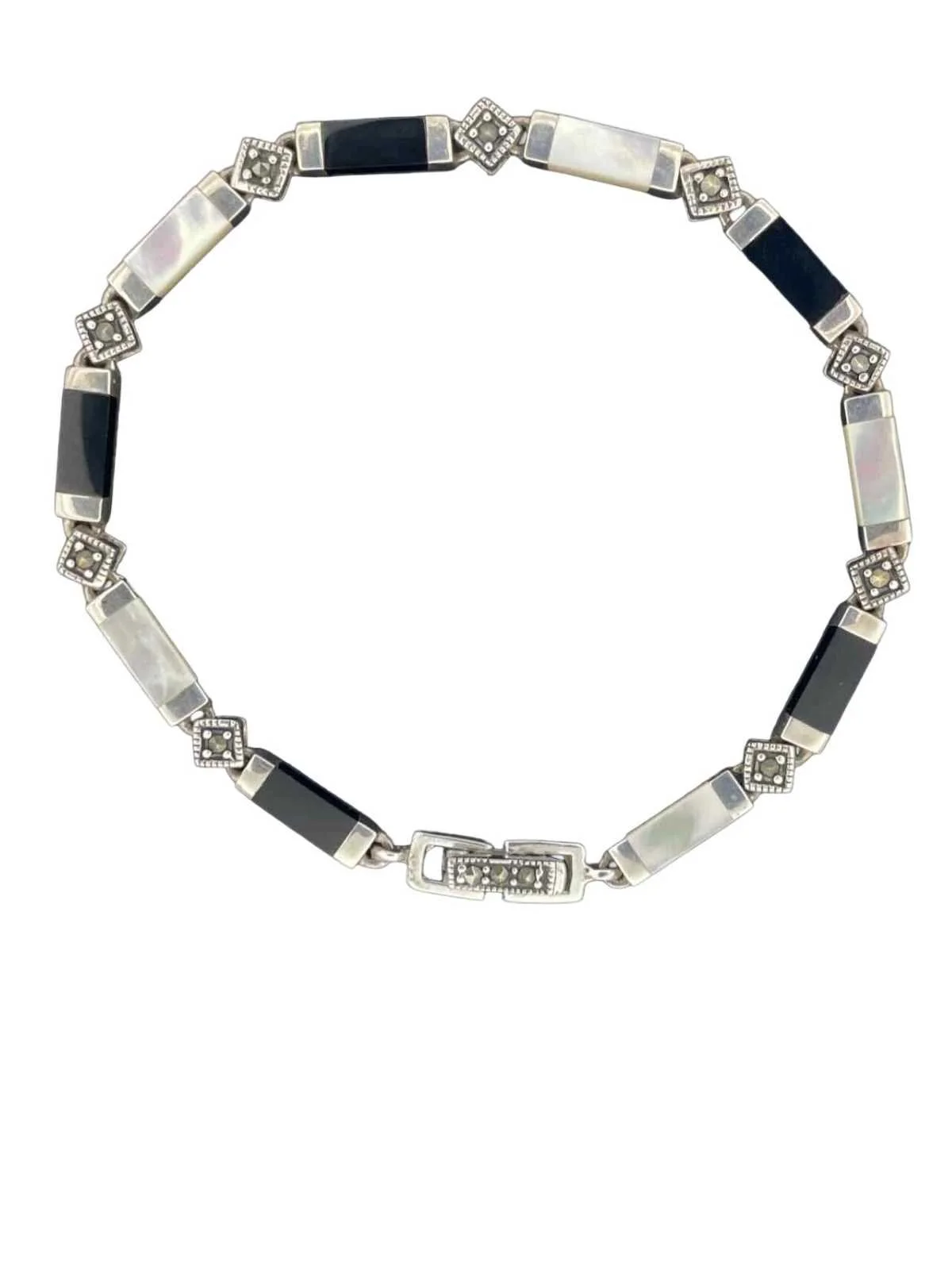 A silver necklace with black and white rectangular and square segments.
