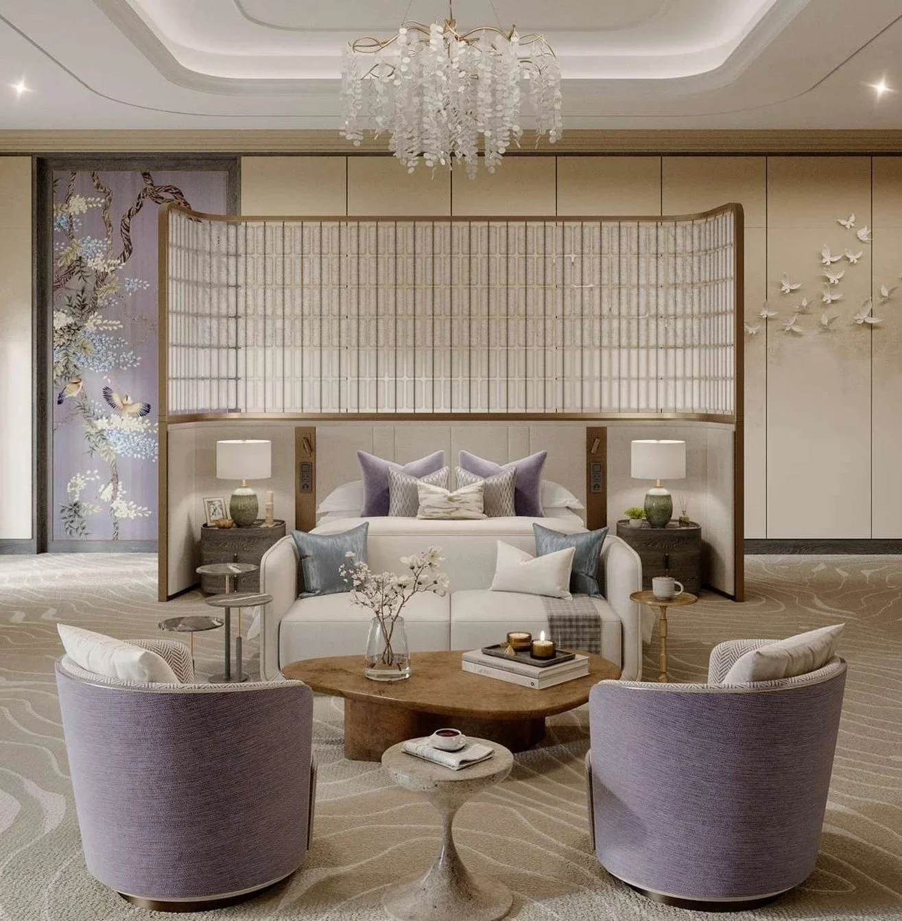 Elegant hotel room with a bed, side tables with lamps, a white sofa with pillows, a round wooden coffee table with flowers, and two purple armchairs, all in a neutral color palette.
