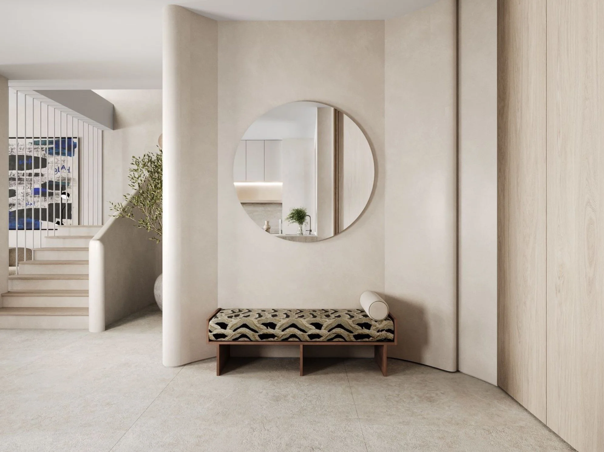 Modern living space with a beige color palette, a round mirror on the wall, a patterned bench at the entrance, and plants near a staircase.