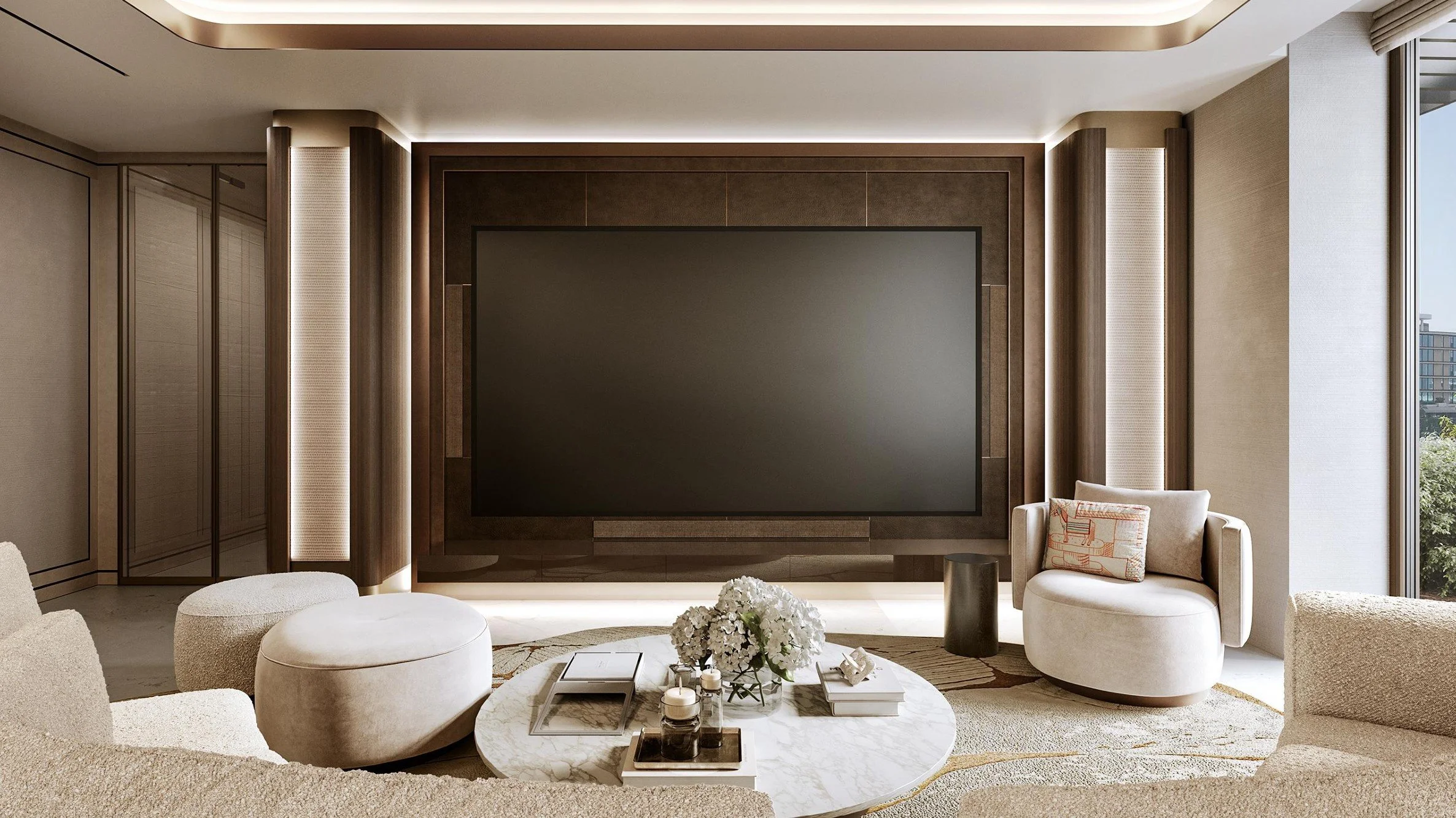 Modern living room with beige sofas, white ottomans, marble coffee table, and a large flat-screen TV on a feature wall. Decor includes a bouquet of white flowers and candles, with a window showing a cityscape outside.