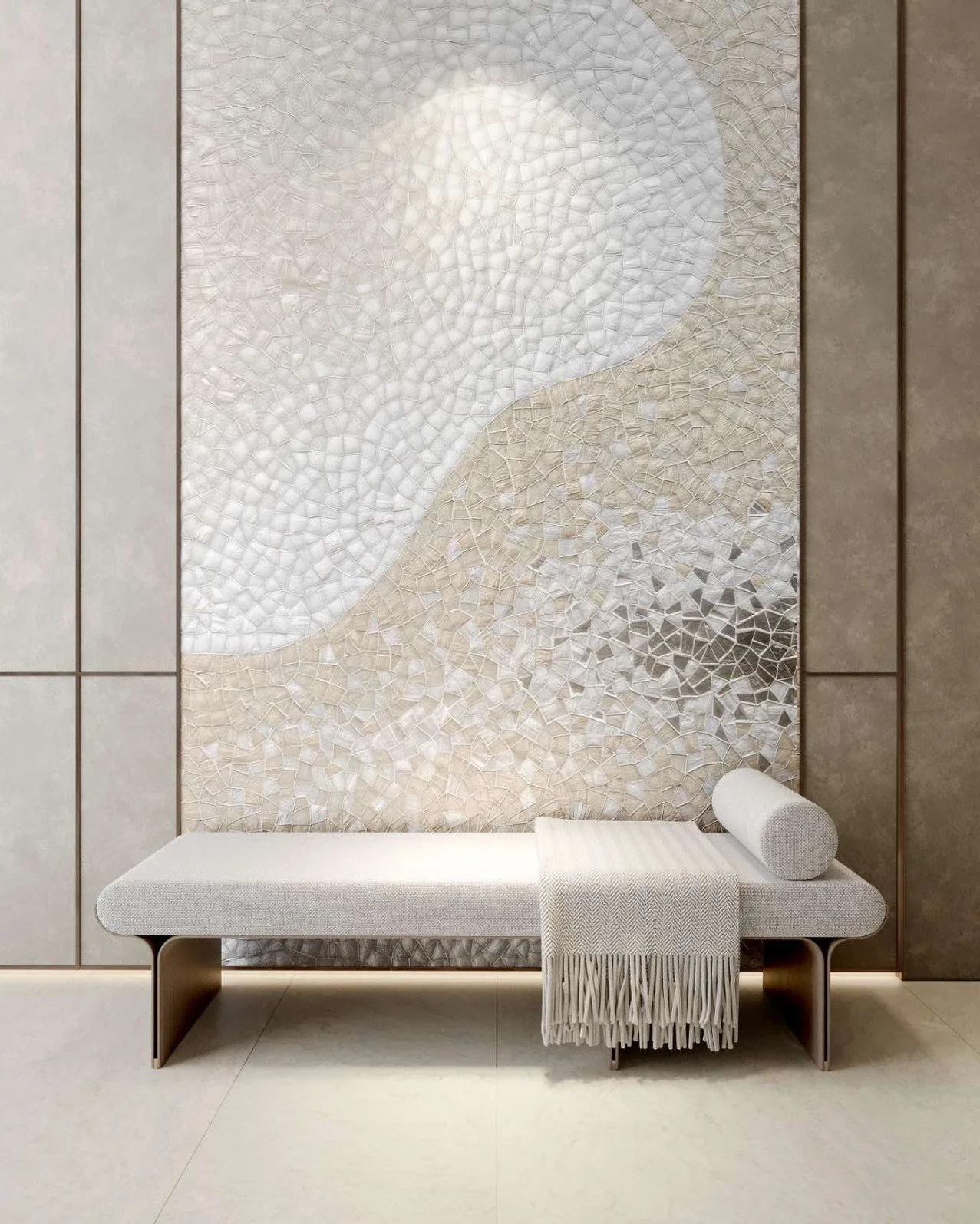 Modern interior design featuring a textured wall with abstract mosaic art, a long white bench with curved edges, a rolled pillow, and a throw blanket with fringe, all in neutral tones.