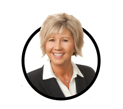 Portrait of a smiling middle-aged woman with short blonde hair, wearing a dark pinstripe blazer and white blouse.