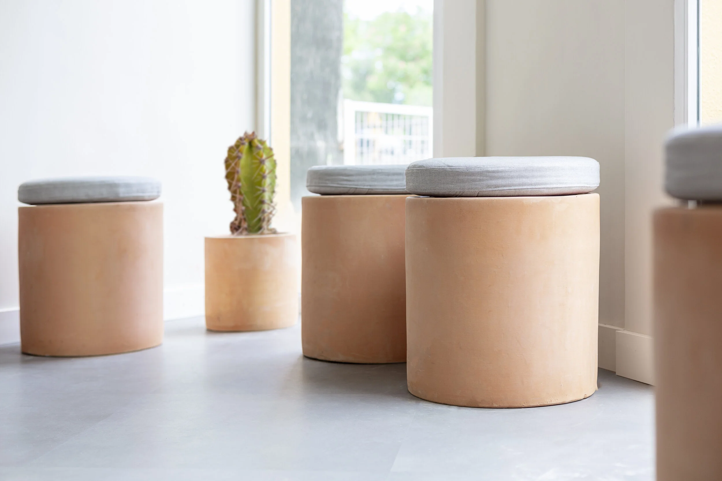 Ceroconuno esthetic center stools in reception in Madrid designed by Wanna
