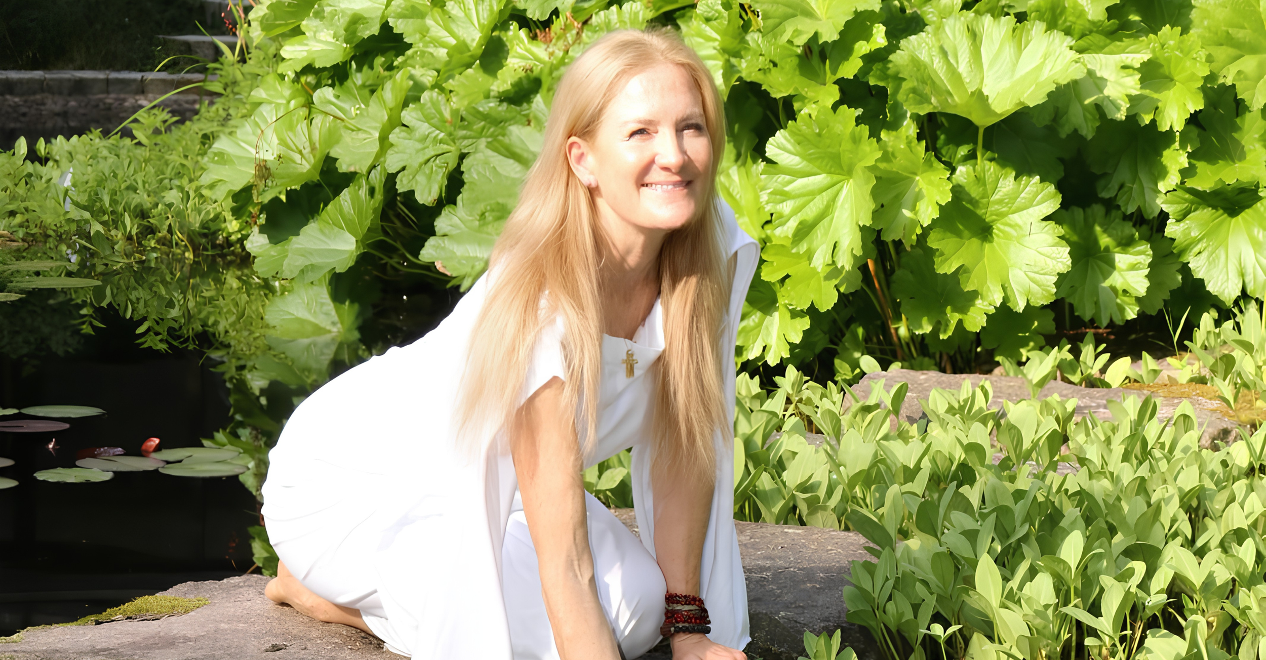 Stephanie Schneider Rittmann of Aummagate in white dress at the magical healing pond