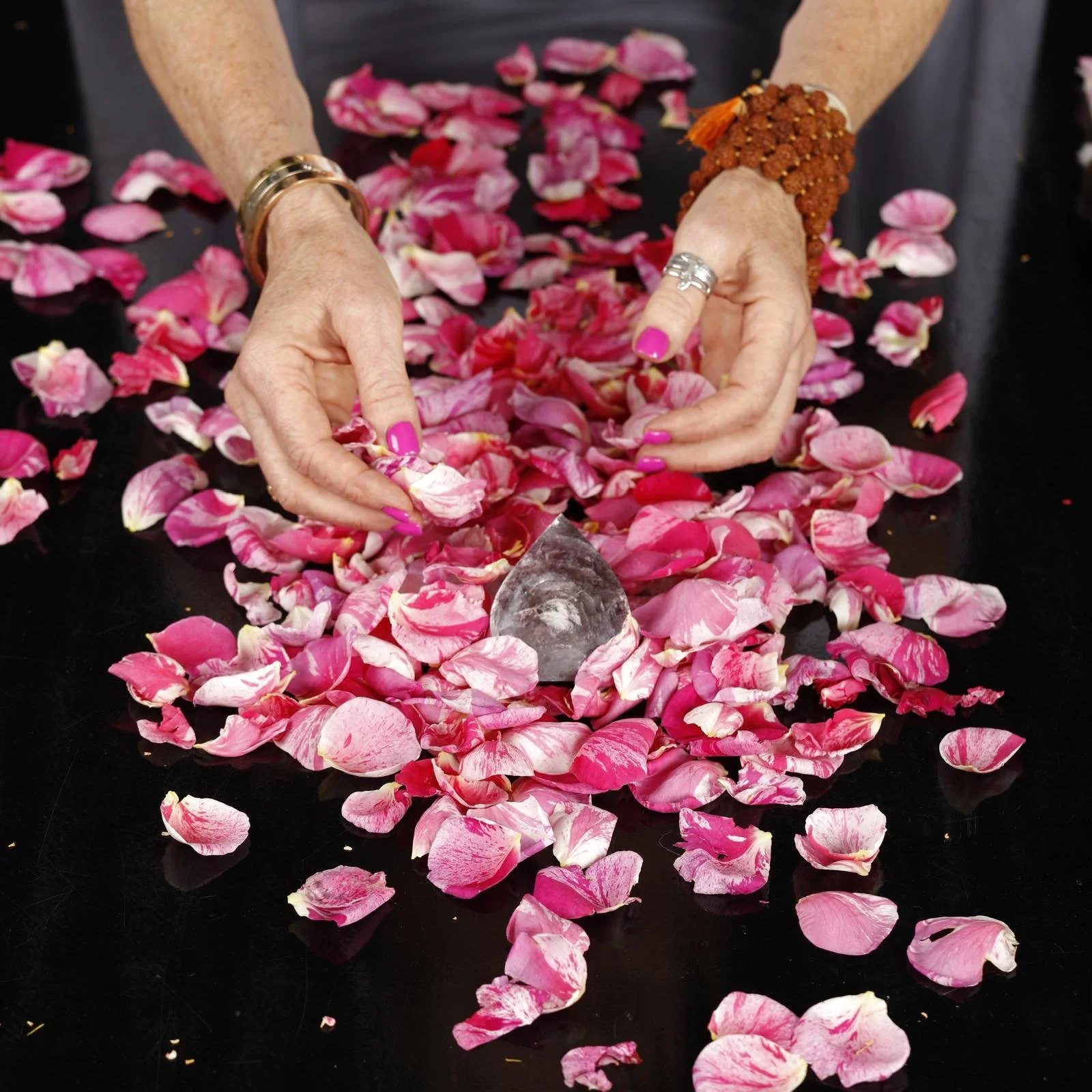Priestess Stephanie Schneider Rittman of Aummagate with pink roses and healing crystal