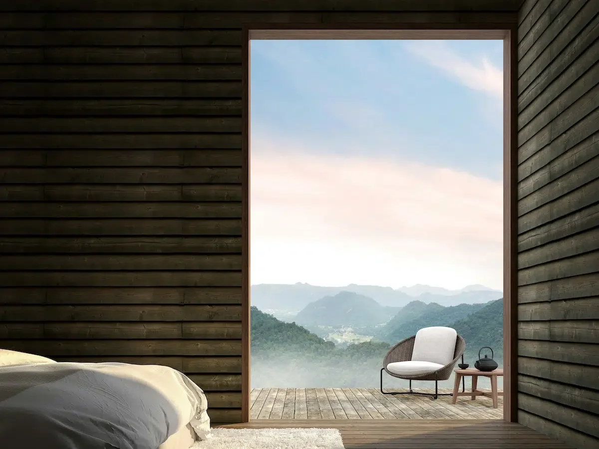 Holzhaus mit Blick vom Bett auf Terrasse undins Tal