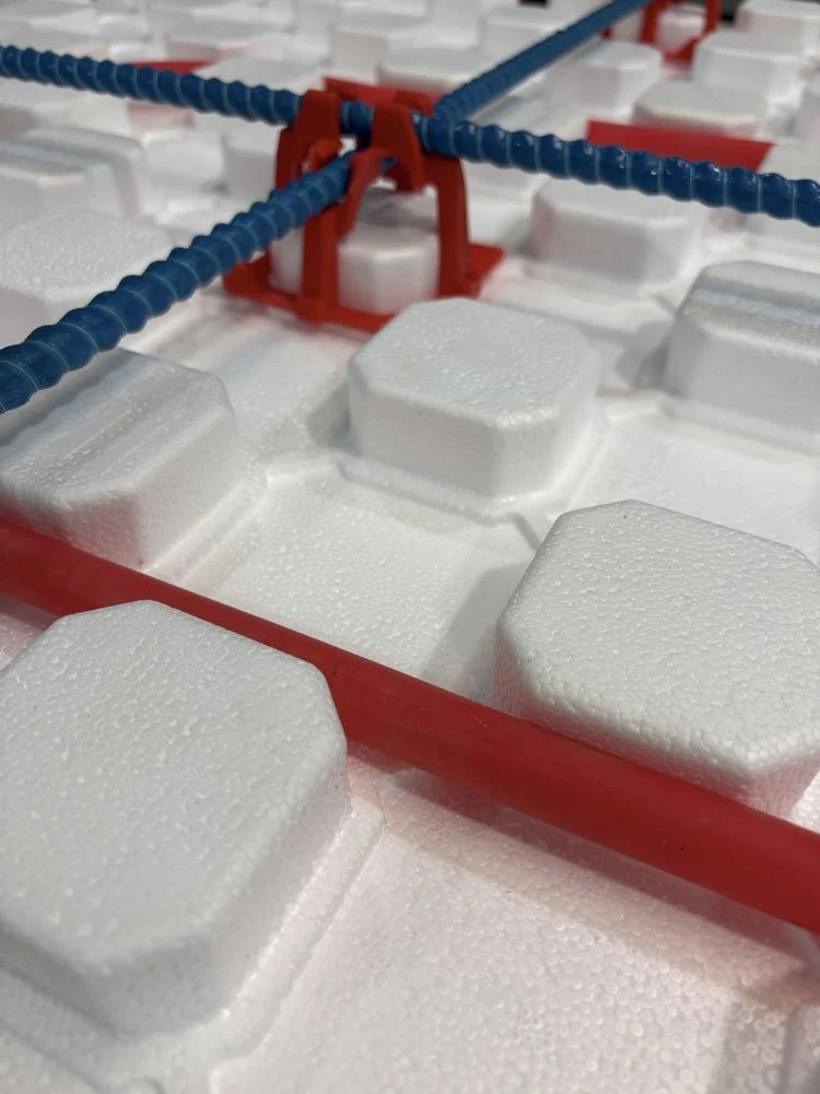Close-up of SuperPex foam product with pipe and rebar chairs as a complete heated floor package.