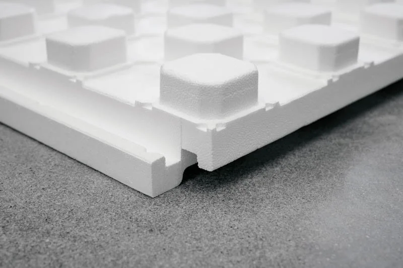 Close-up of white SuperPx Panel with hexagonal texture embedded with a SuperForm 'S' icon
