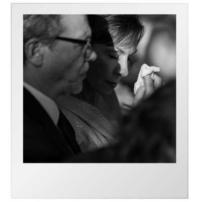 Close-up black and white photo of two people, a man and woman, with their eyes closed, appearing contemplative or emotional.