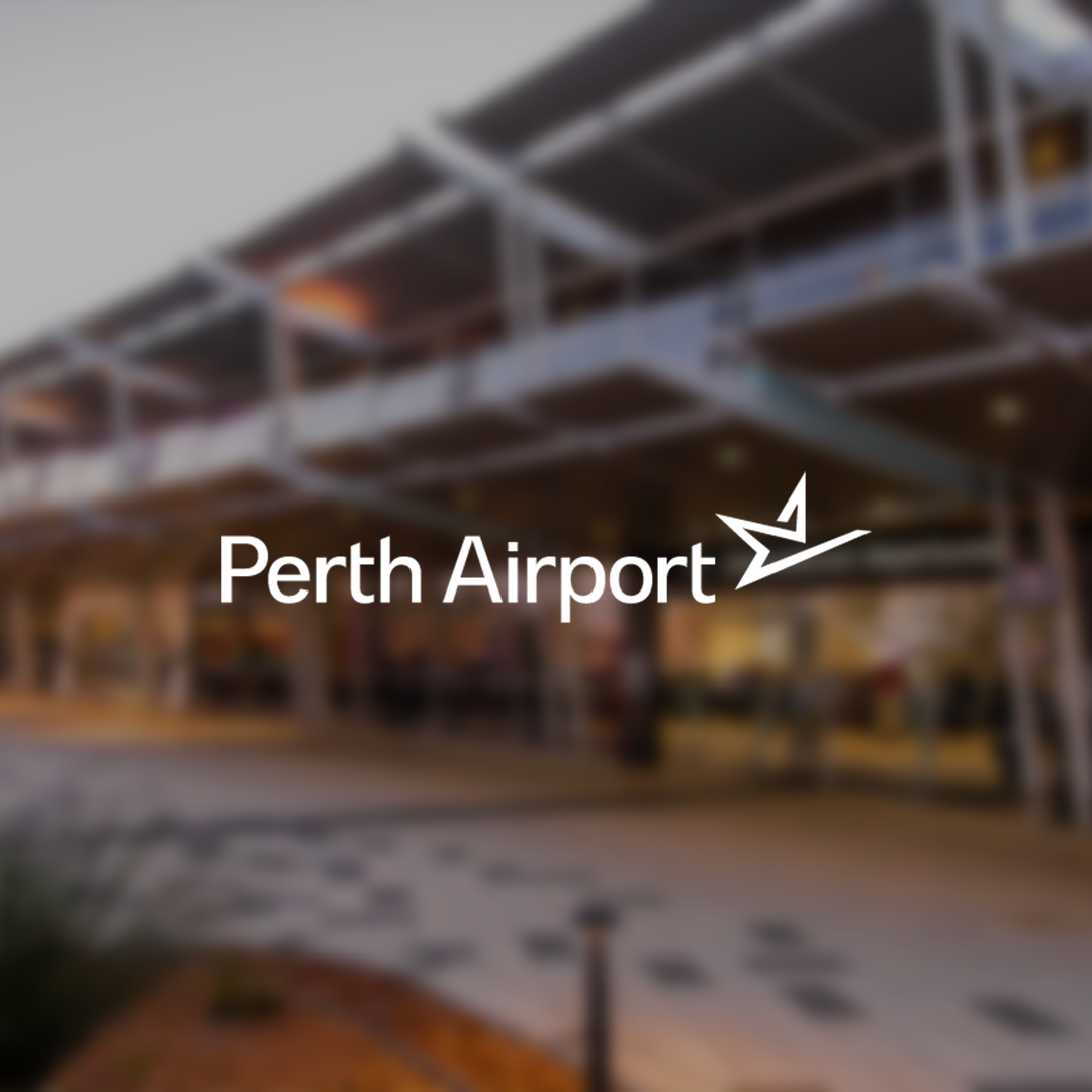 Blurred view of Perth Airport terminal facade with the airport logo and name overlayed.
