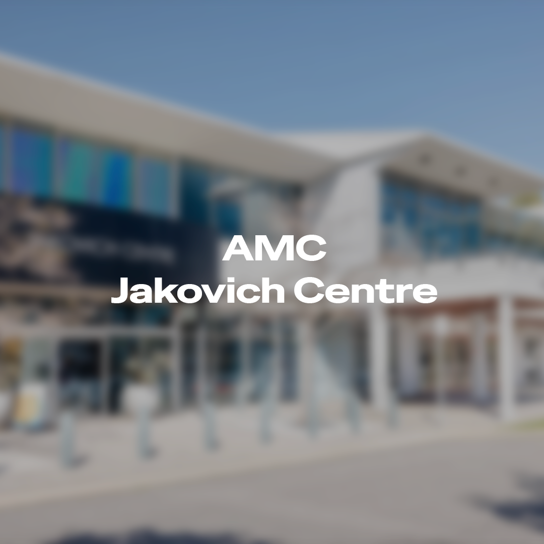 Blurred exterior of AMC Jakovich Centre building with text overlay.