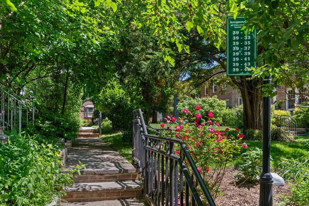 A leafy pedestrian path through Sunnyside Gardens