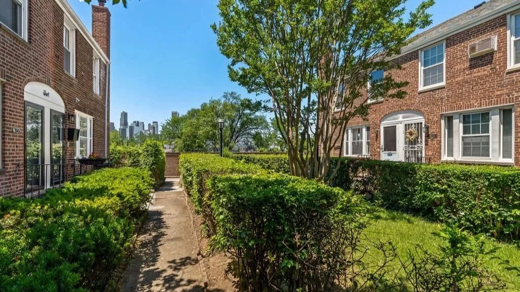 Shared interior garden court framed by Sunnyside Gardens row houses