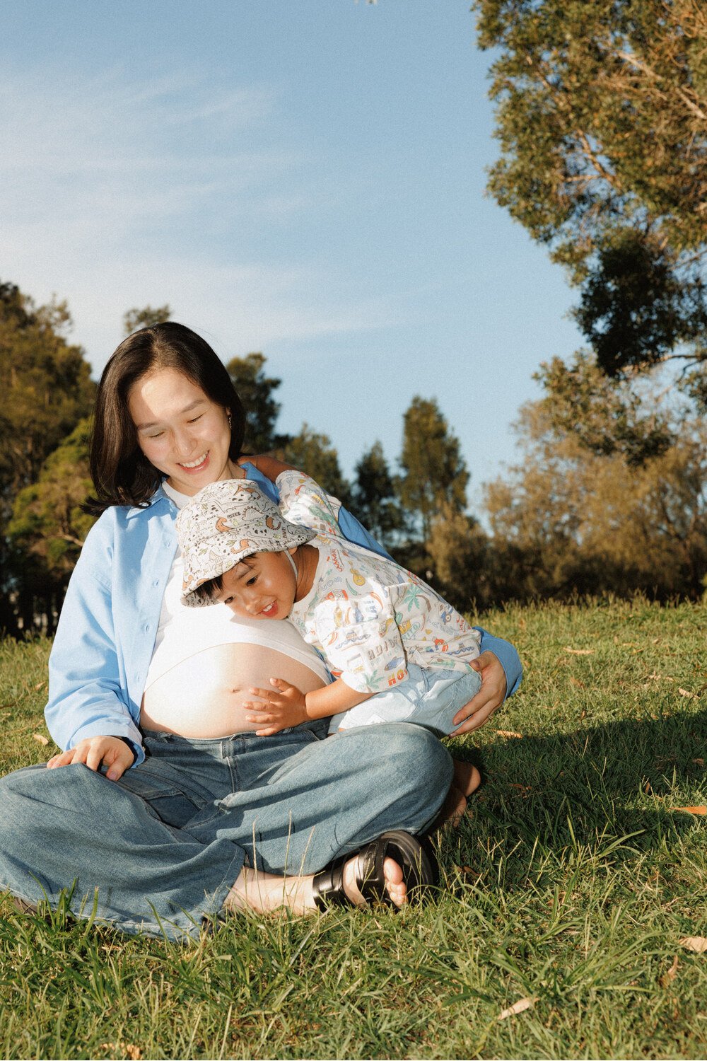 Bump cuddle: Toddler resting their cheek against their pregnant mother’s bump.