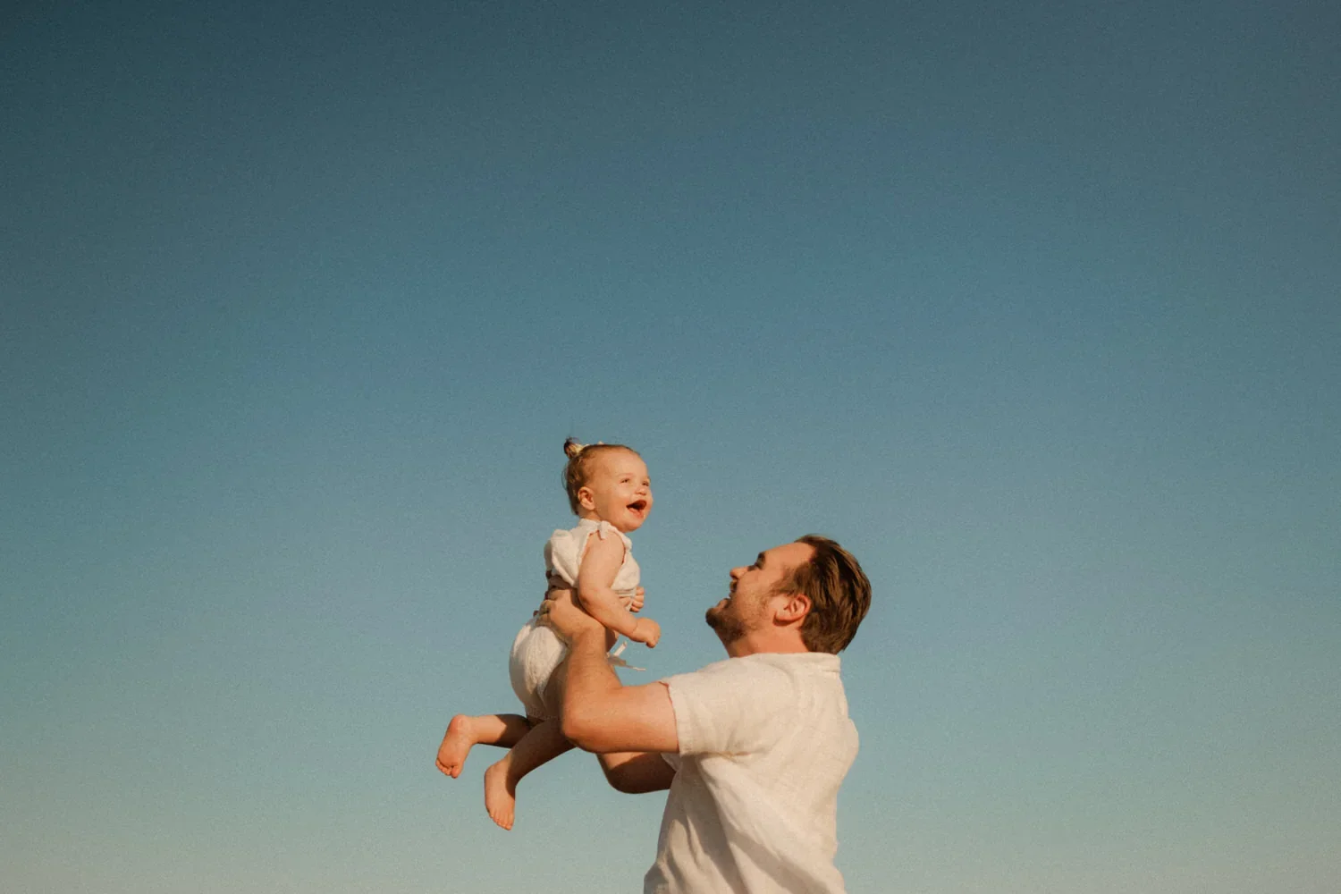 21-little-manly-father-lifting-child-blue-sky.webp