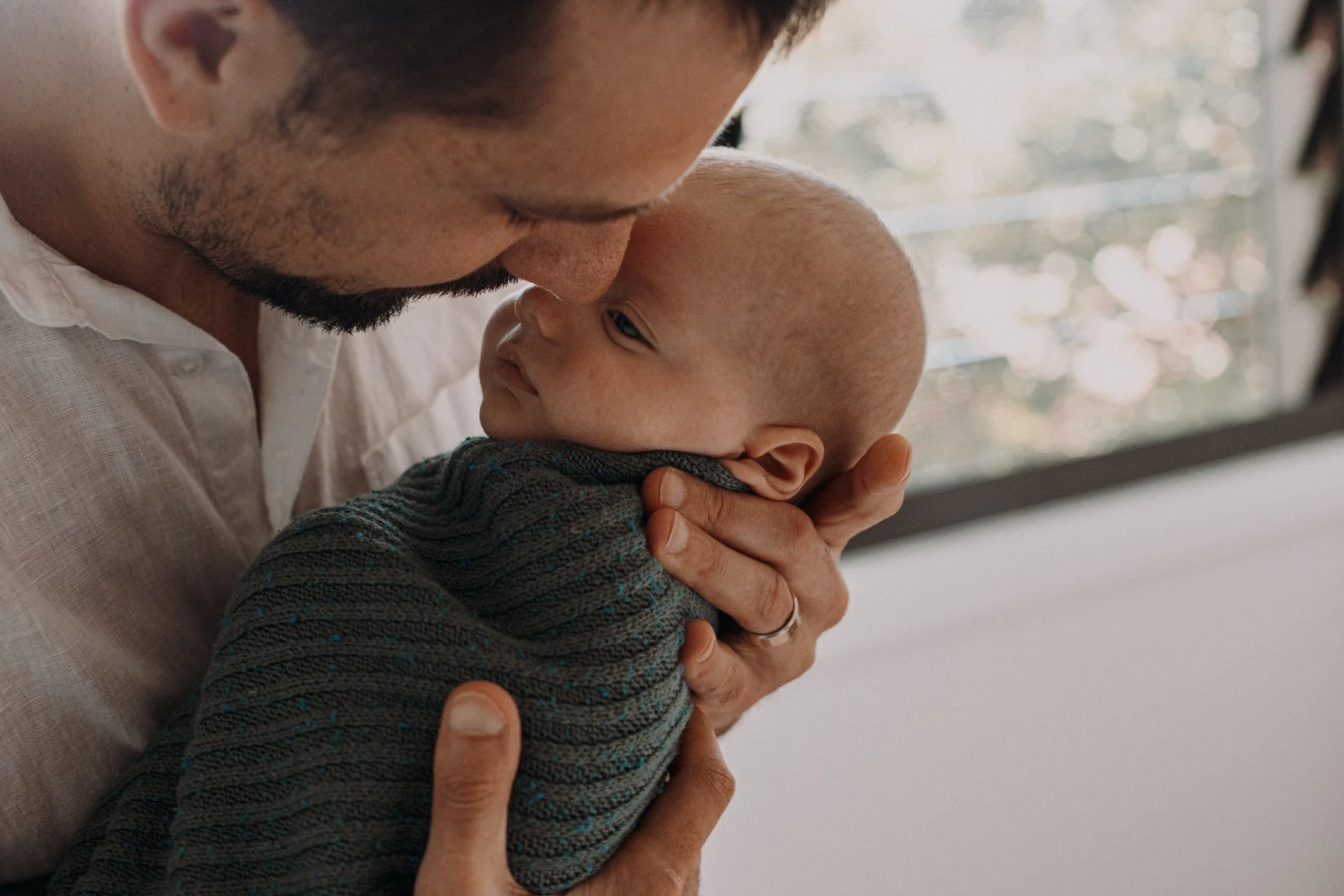 A father holding his newborn baby