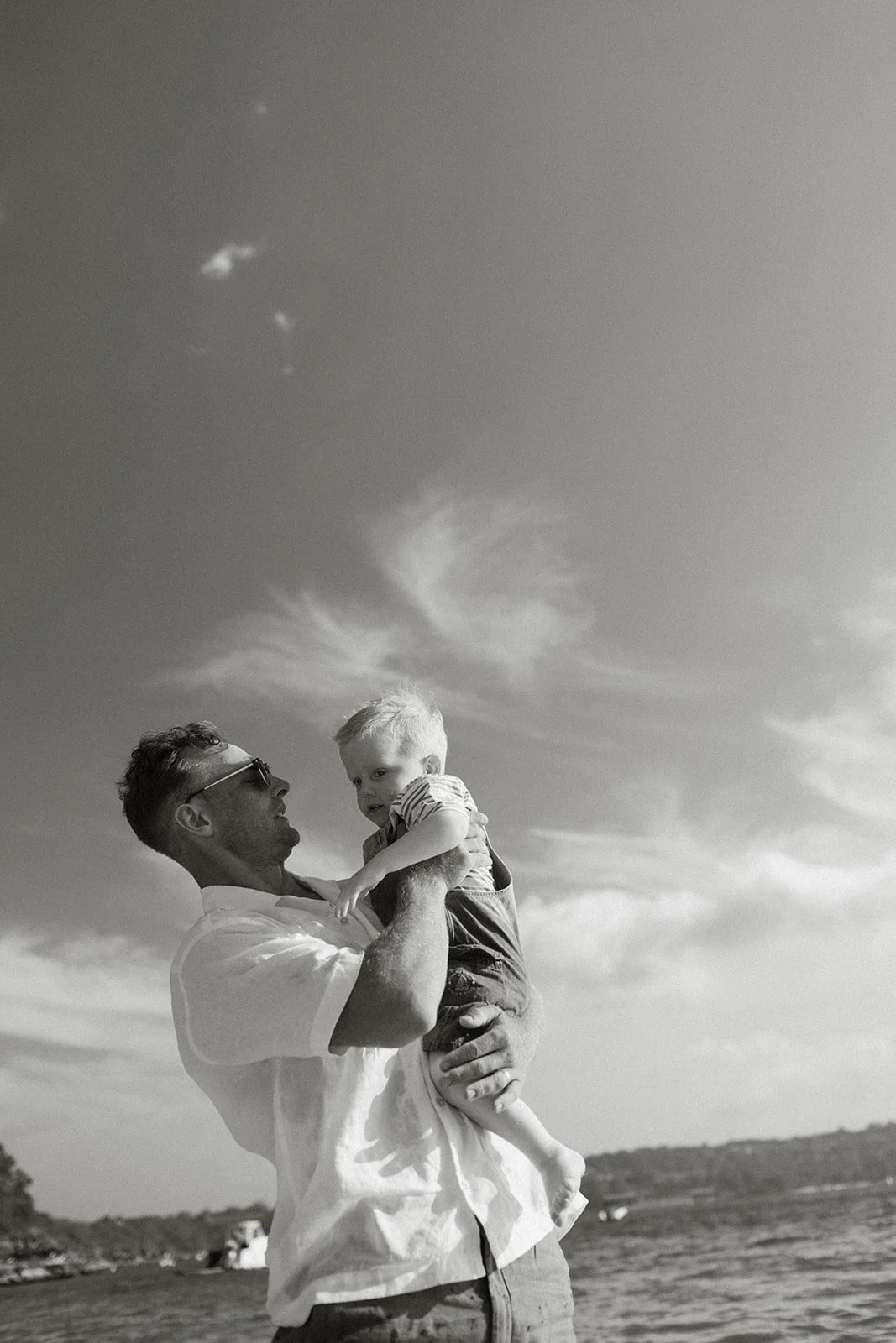 Dad holding baby boy on the beach