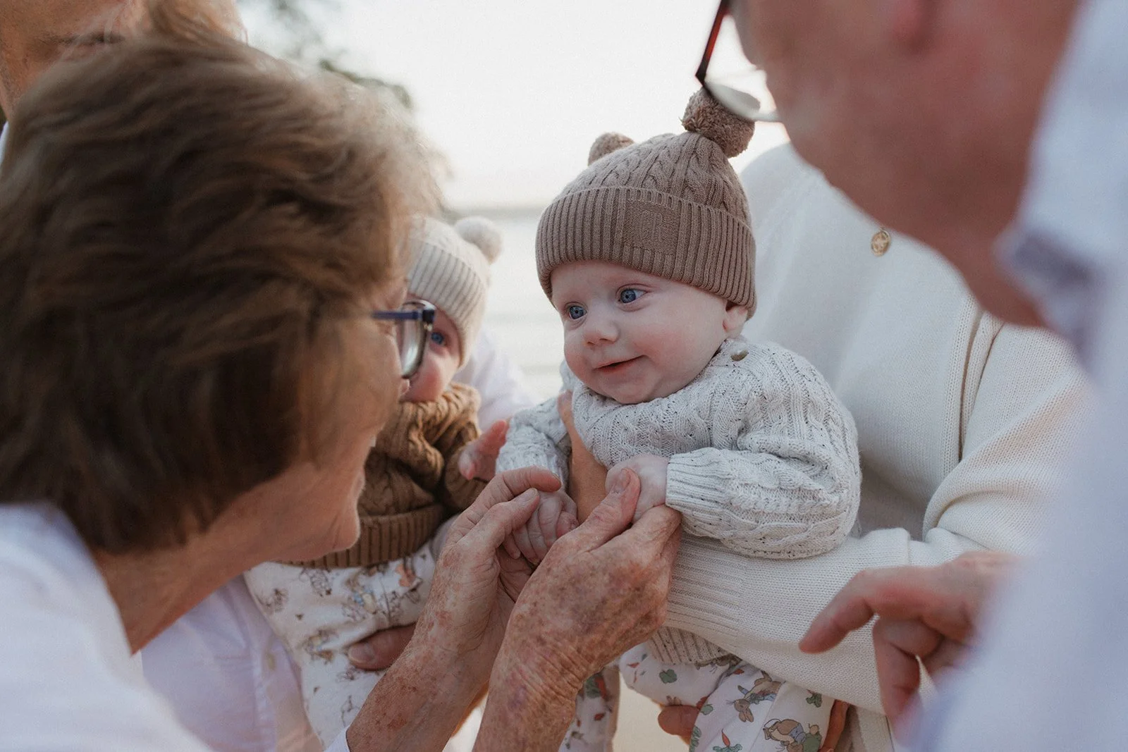 Grandmother with baby boy and family