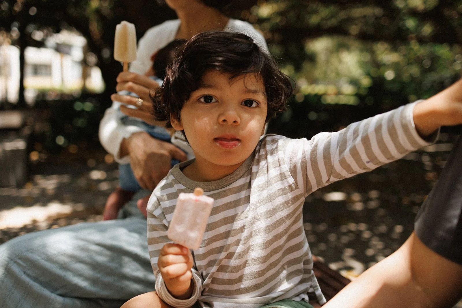 Toddler eating and ice cream in the park
