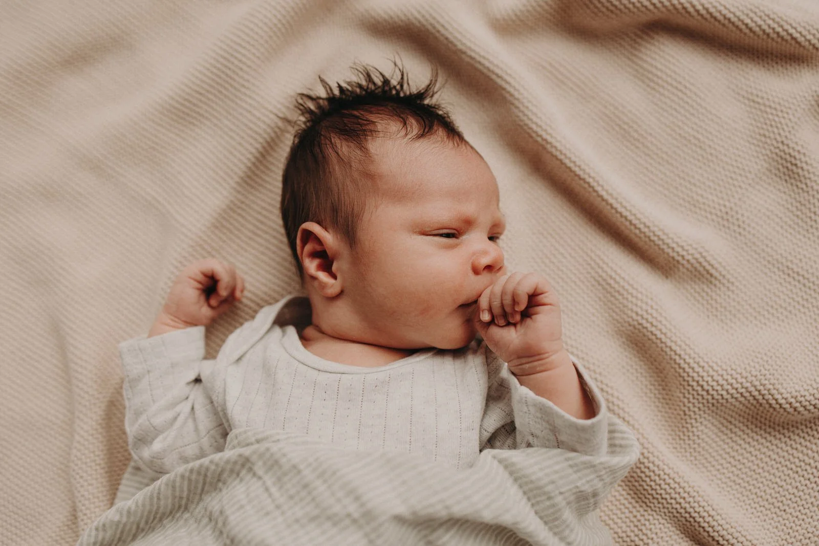 Newborn baby on bed