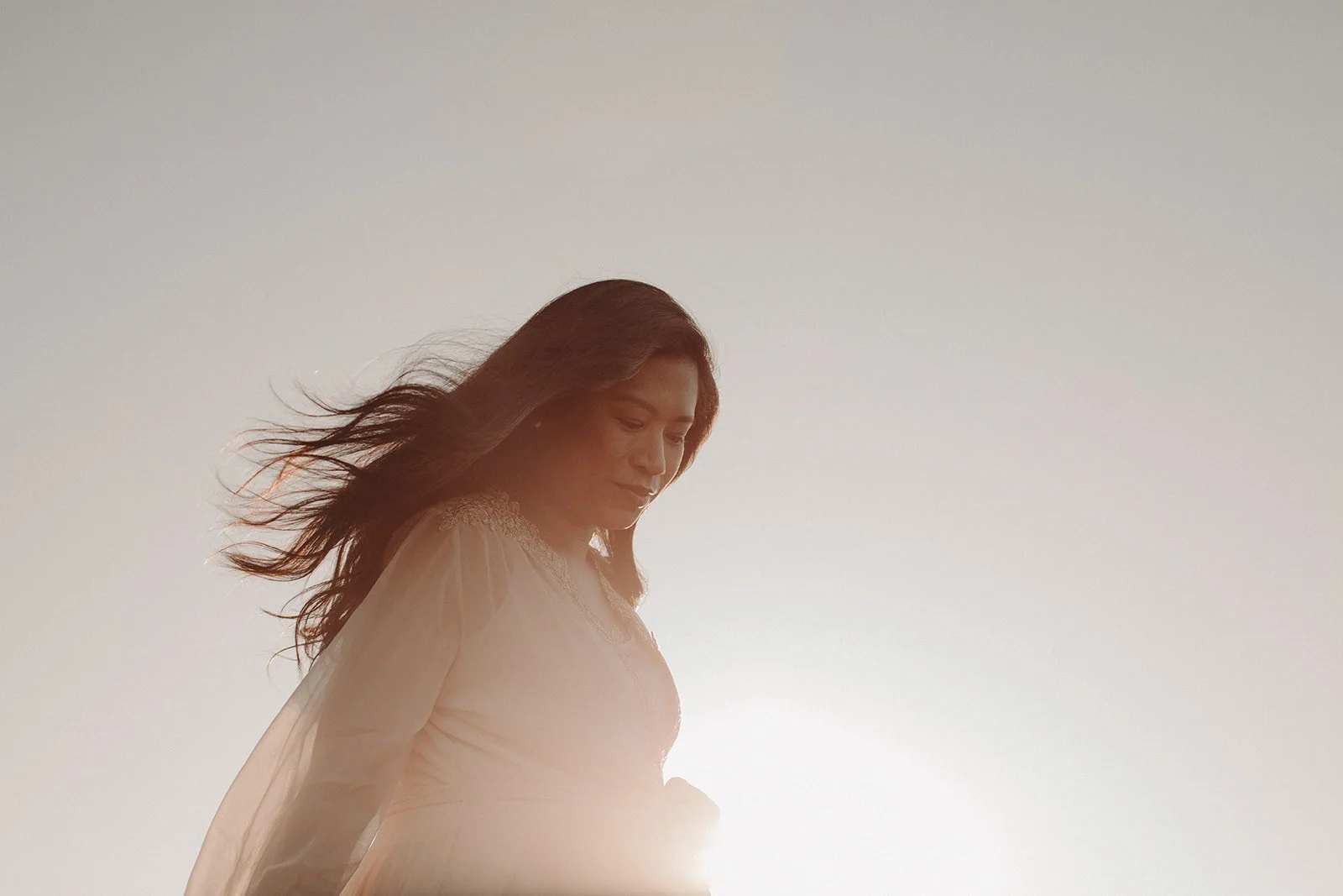 Mum with wavy hair with sky background