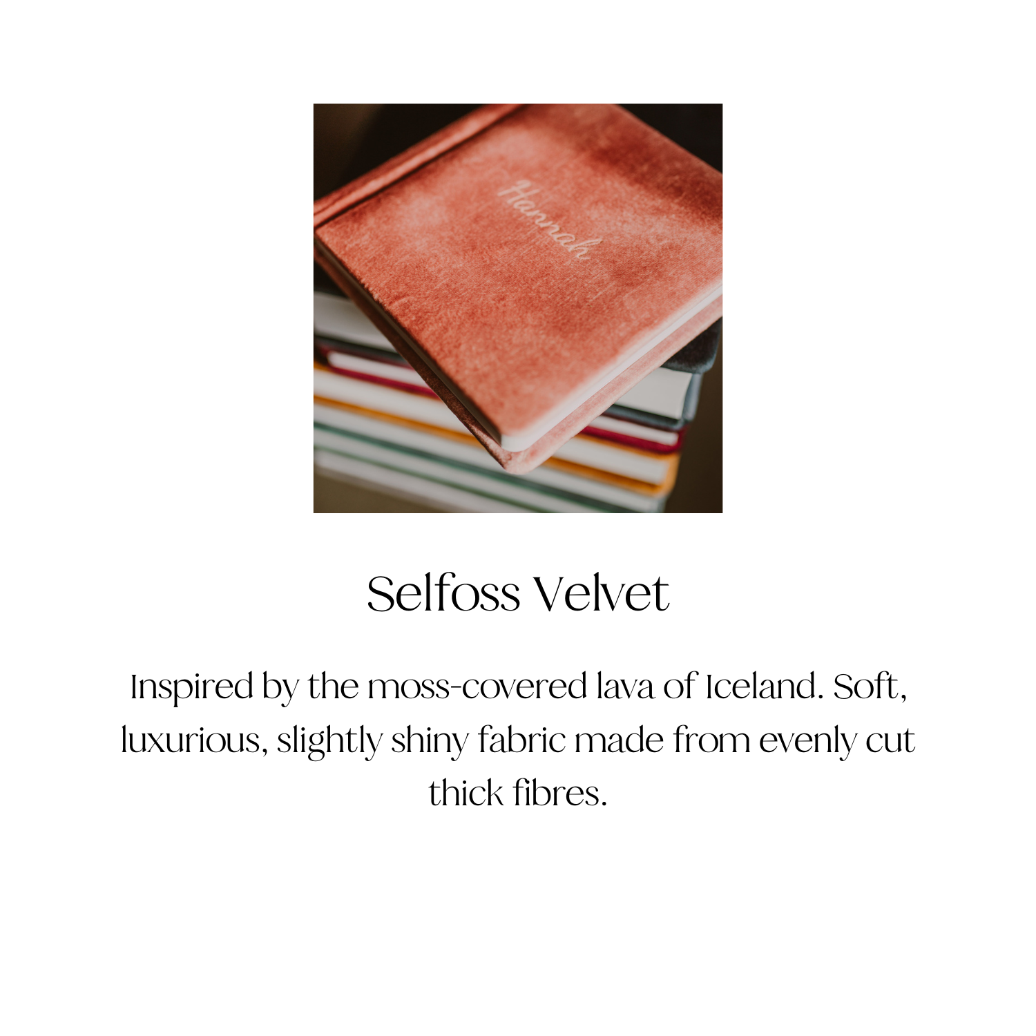 A pink velvet book cover with the word 'Happiness' written on it, placed on top of a stack of colorful books with spines in black, white, and red.