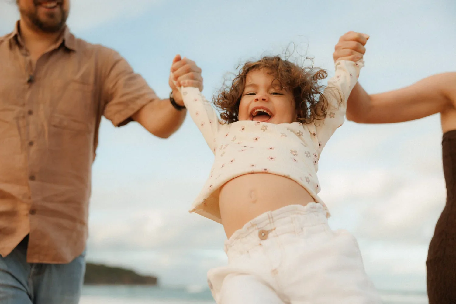 26-little-manly-parents-swinging-toddler.webp