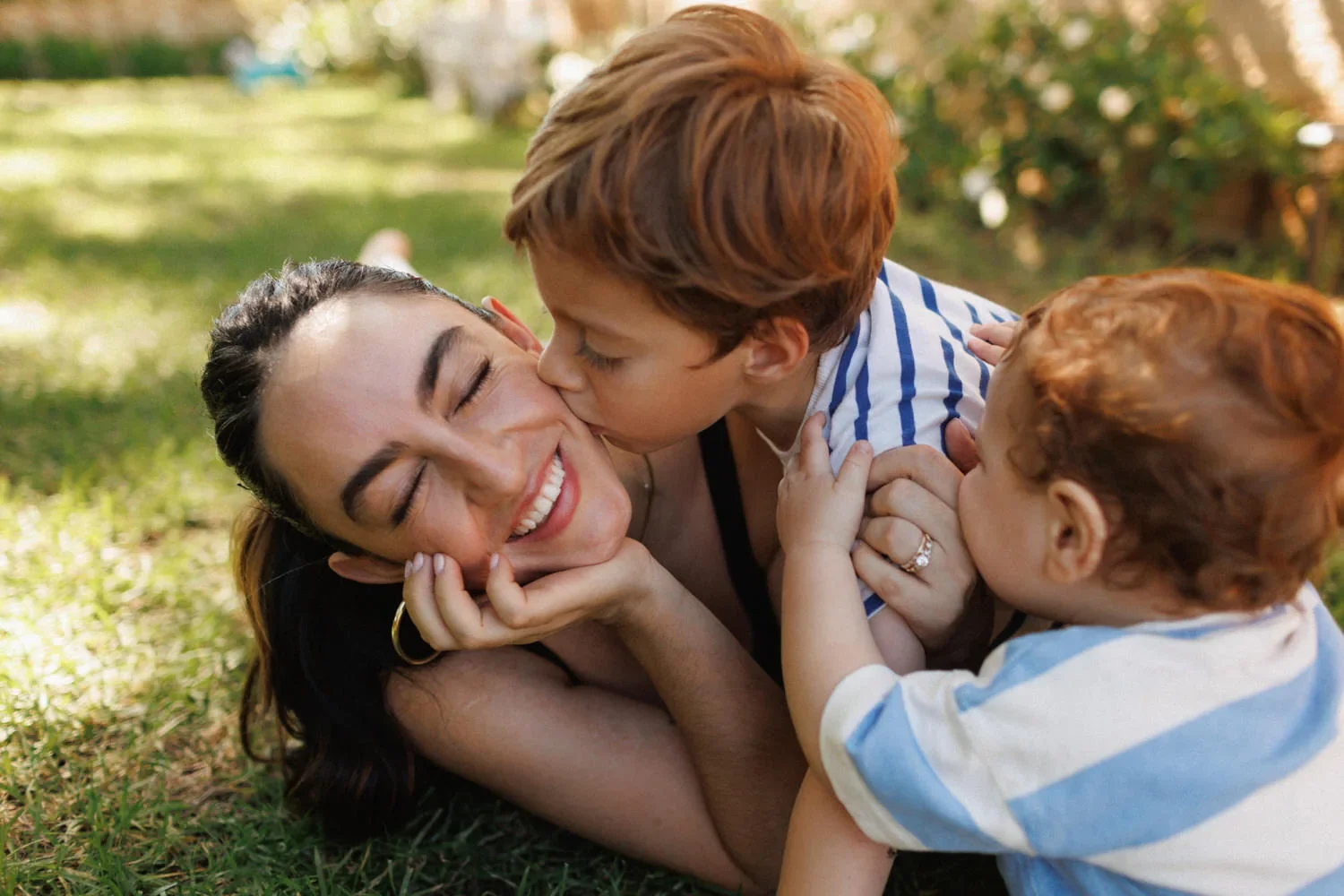 06-little-manly-mother-sons-garden-kisses.webp
