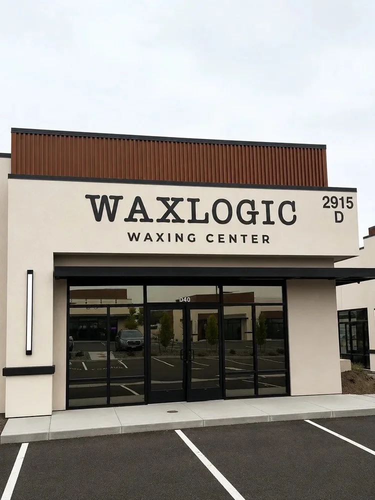 Exterior view of Waxlogic Waxing Center, showcasing the entrance and signage in a modern urban setting.