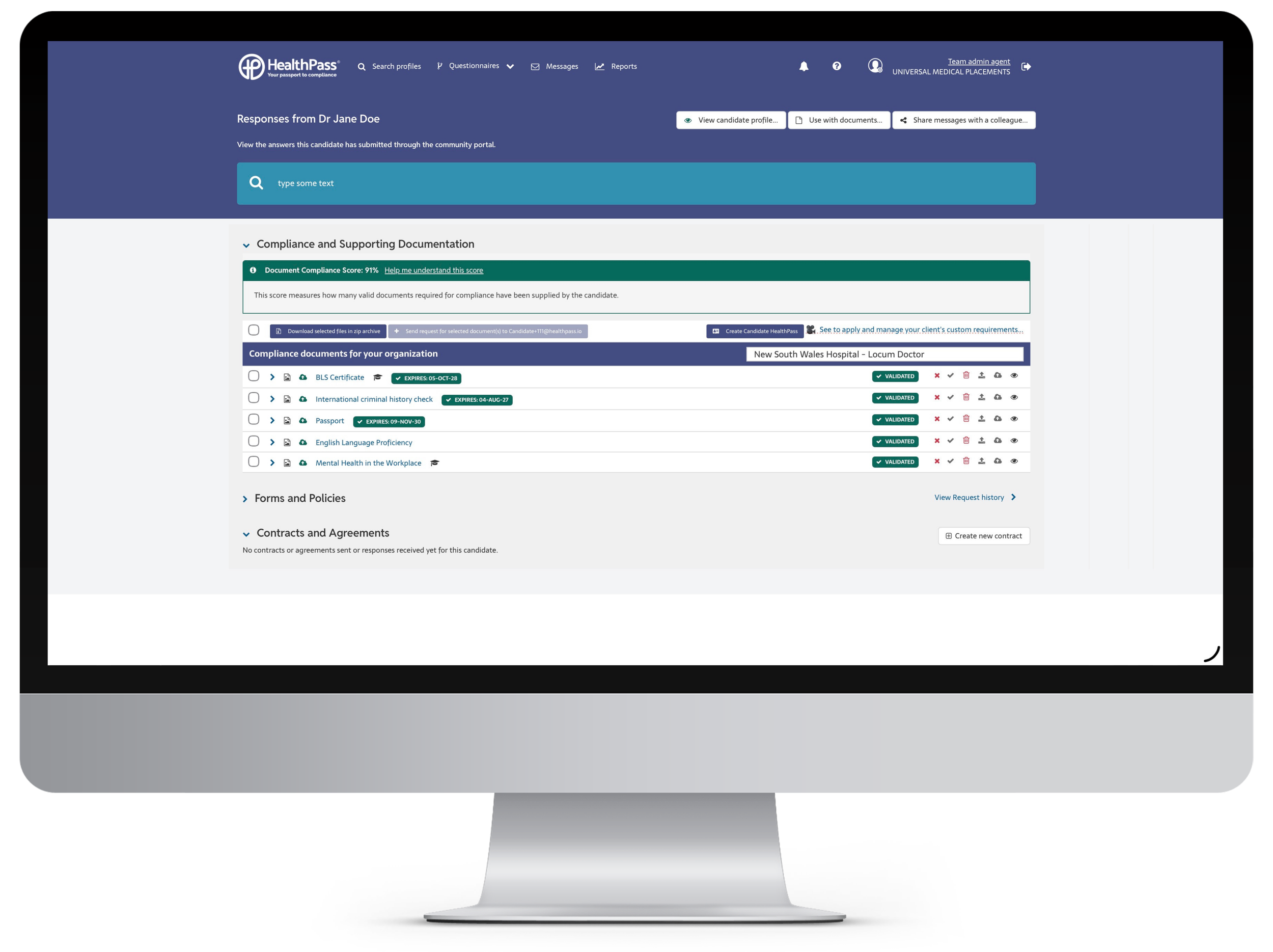 Computer monitor displaying a healthcare compliance dashboard with list of documents such as BLS Certificate, criminal history check, passport, and language proficiency marked as validated.