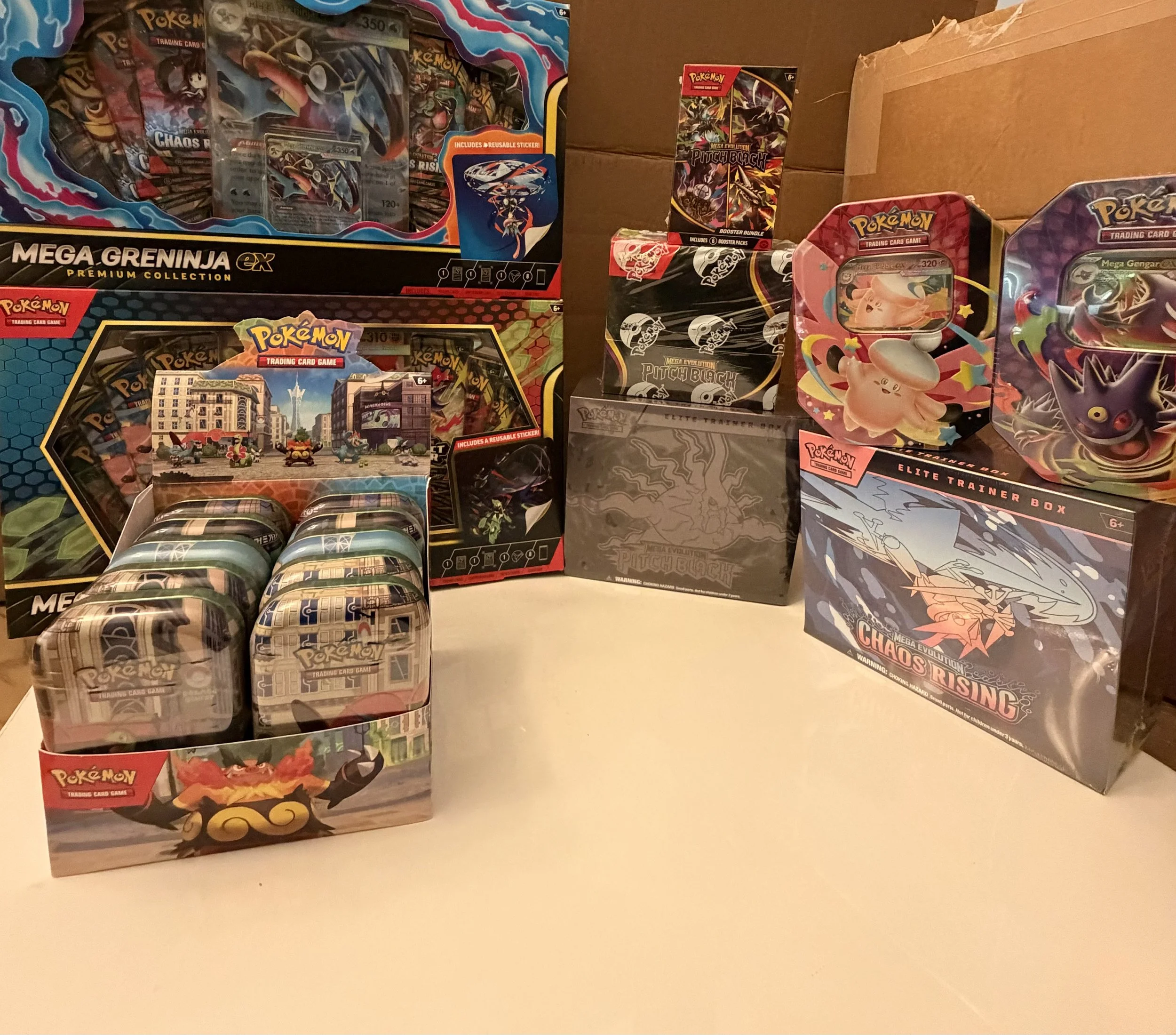 Various Pokémon trading card game boxes and packs arranged on a table.