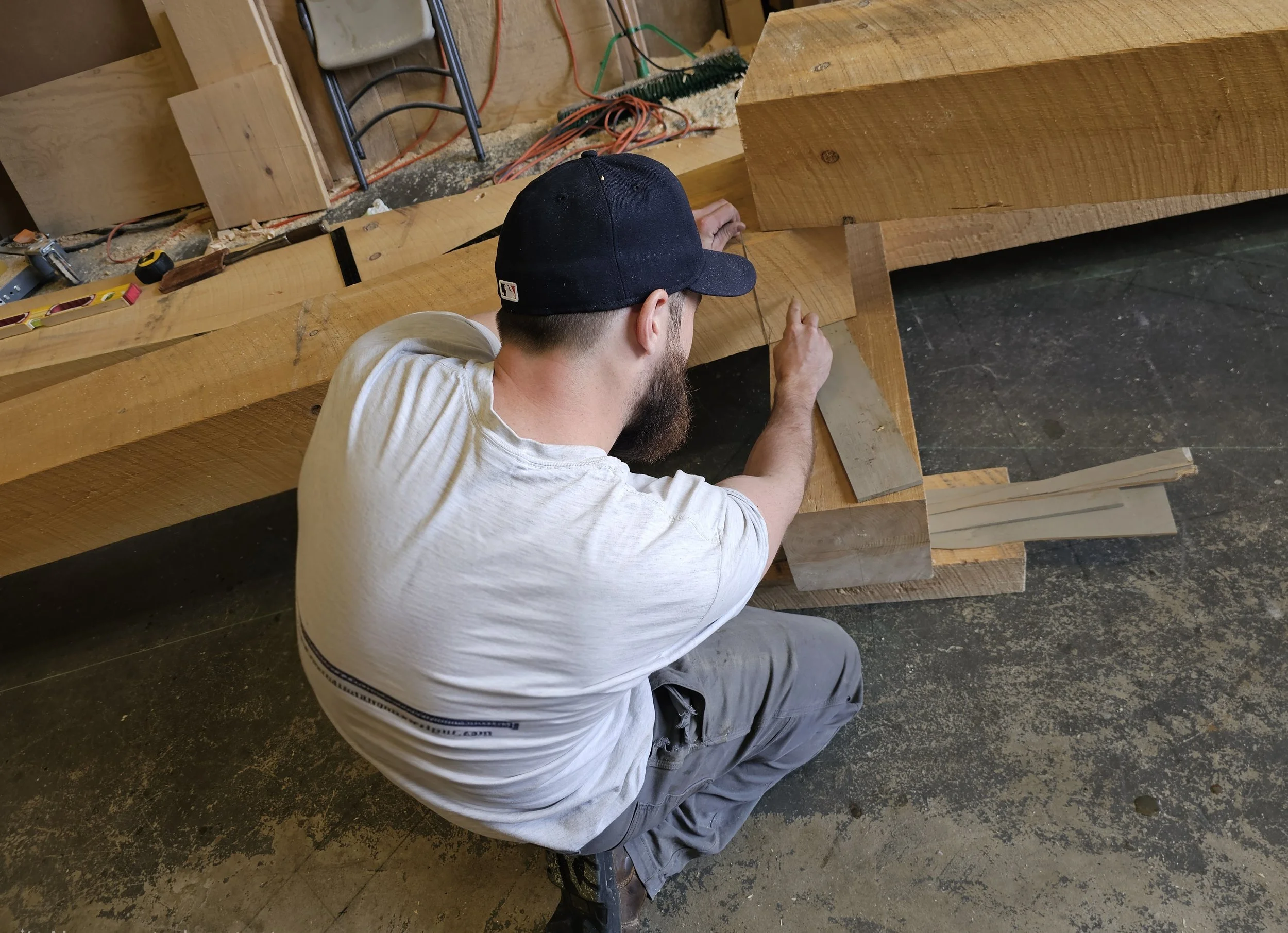 Scribing timbers with a plumb bob to layout joinery