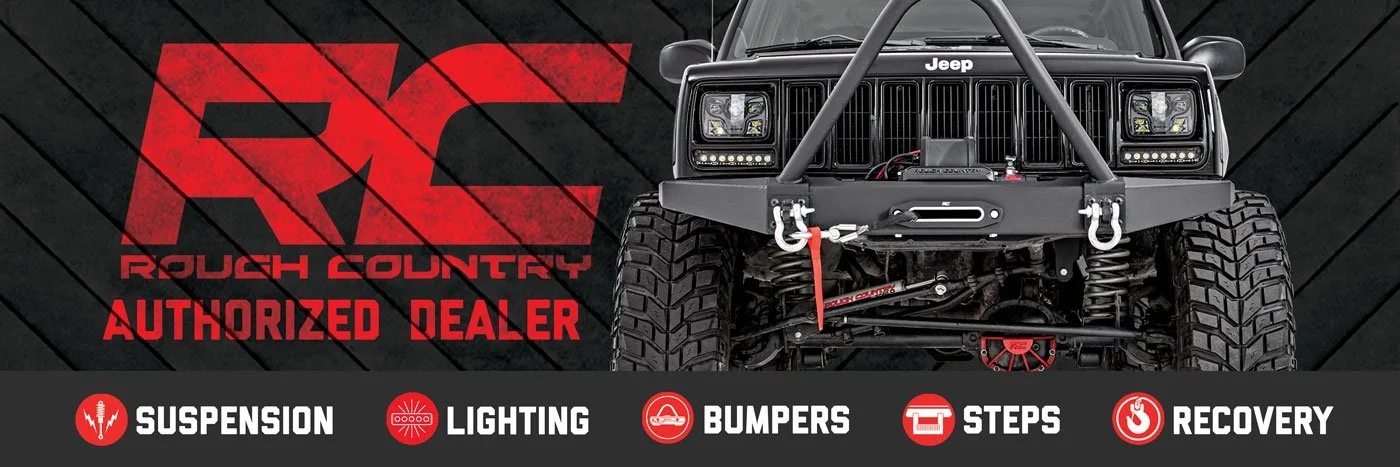 Front view of an off-road modified Jeep vehicle with custom bumper, suspension, and bright LED lights, featuring a