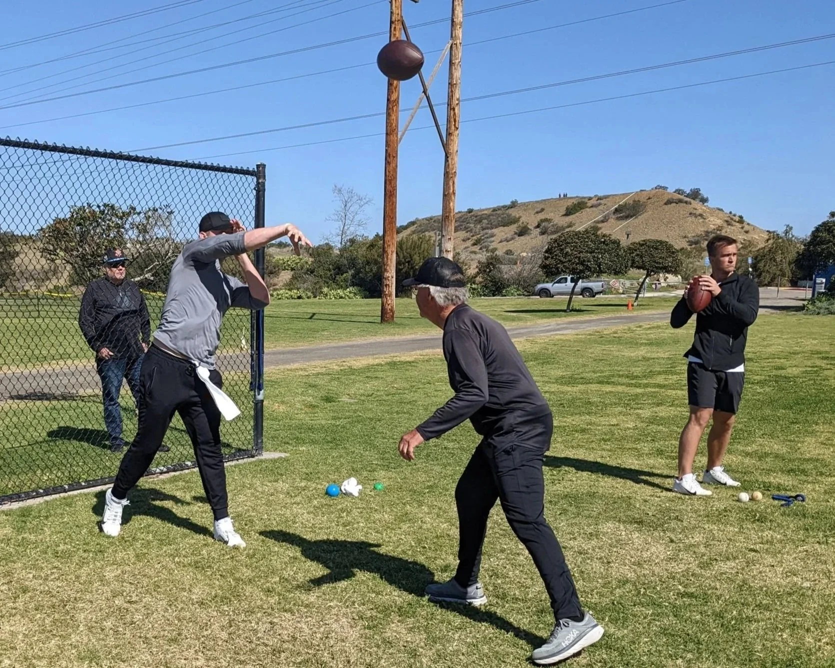 Tom House (Middle), aided by Quarterback Performance Institute Head of QB Development, Justin Arth, training NFL QBs, Mac Jones (left) and Sam Ehlinger (Right) (circa 2024)