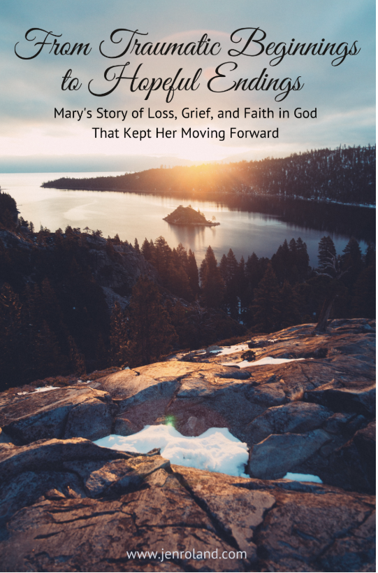 A scenic view of a lake at sunset with trees and rocky terrain in the foreground. The sky is colorful with sunset hues. The text overlay reads, 'From Traumatic Beginnings to Hopeful Endings: Mary's Story of Loss, Grief, and Faith in God That Kept Her Moving Forward.'