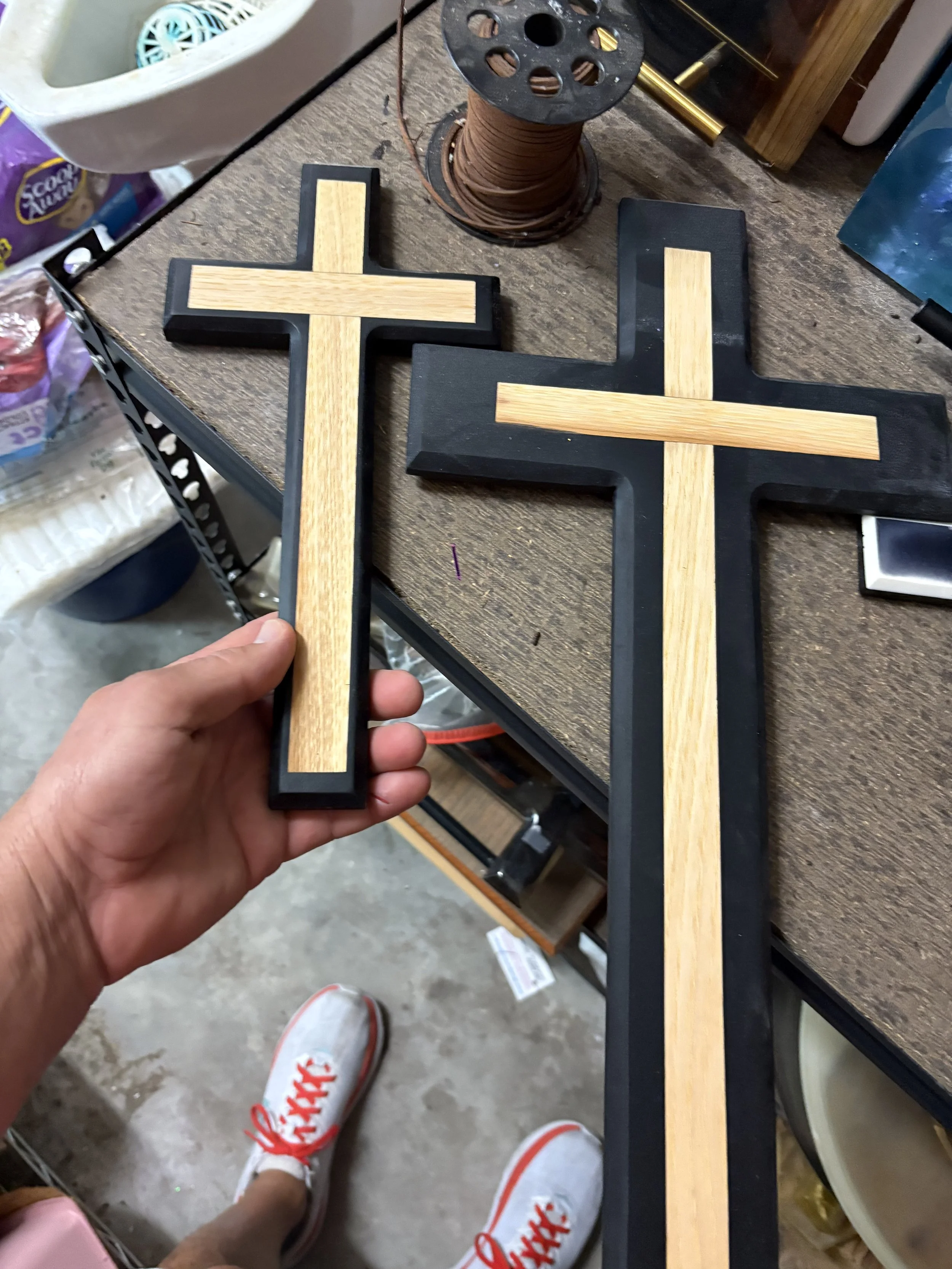 large and small black epoxy crosses with wood

