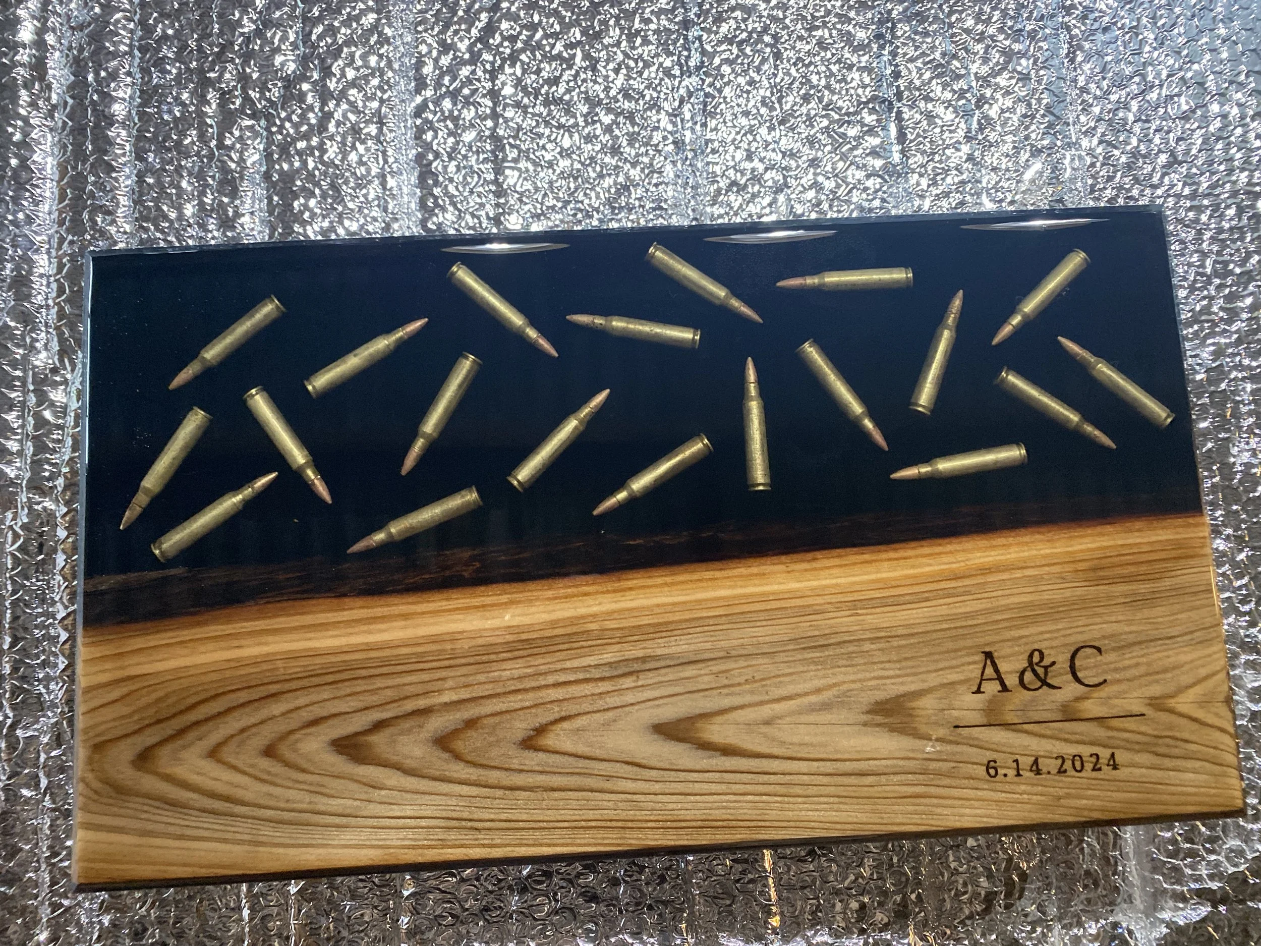 custom sinker cypress charcuterie board with black epoxy and bullets