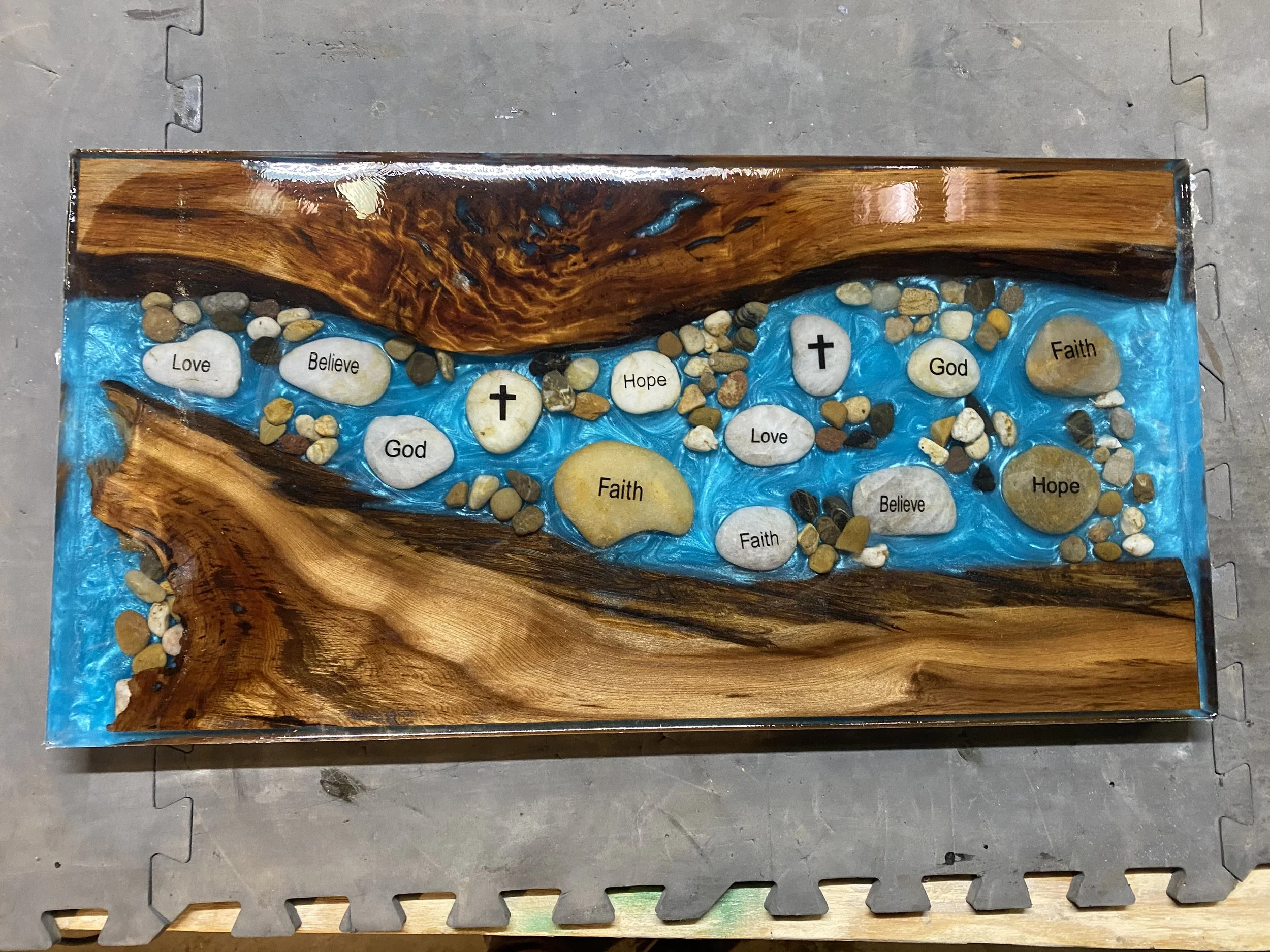 sinker cypress charcuterie board with blue epoxy and faith rocks