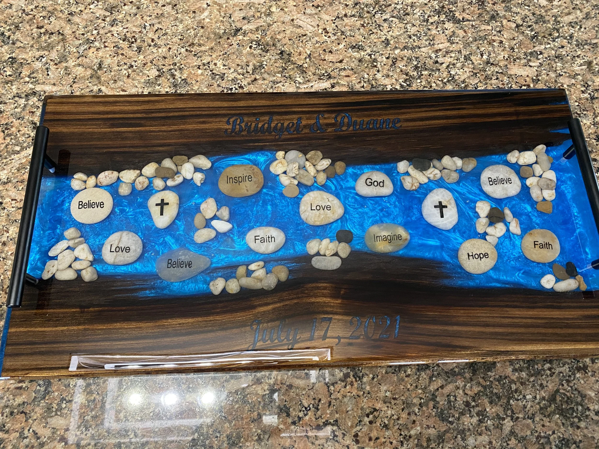 sinker cypress charcuterie board with blue epoxy and faith rocks