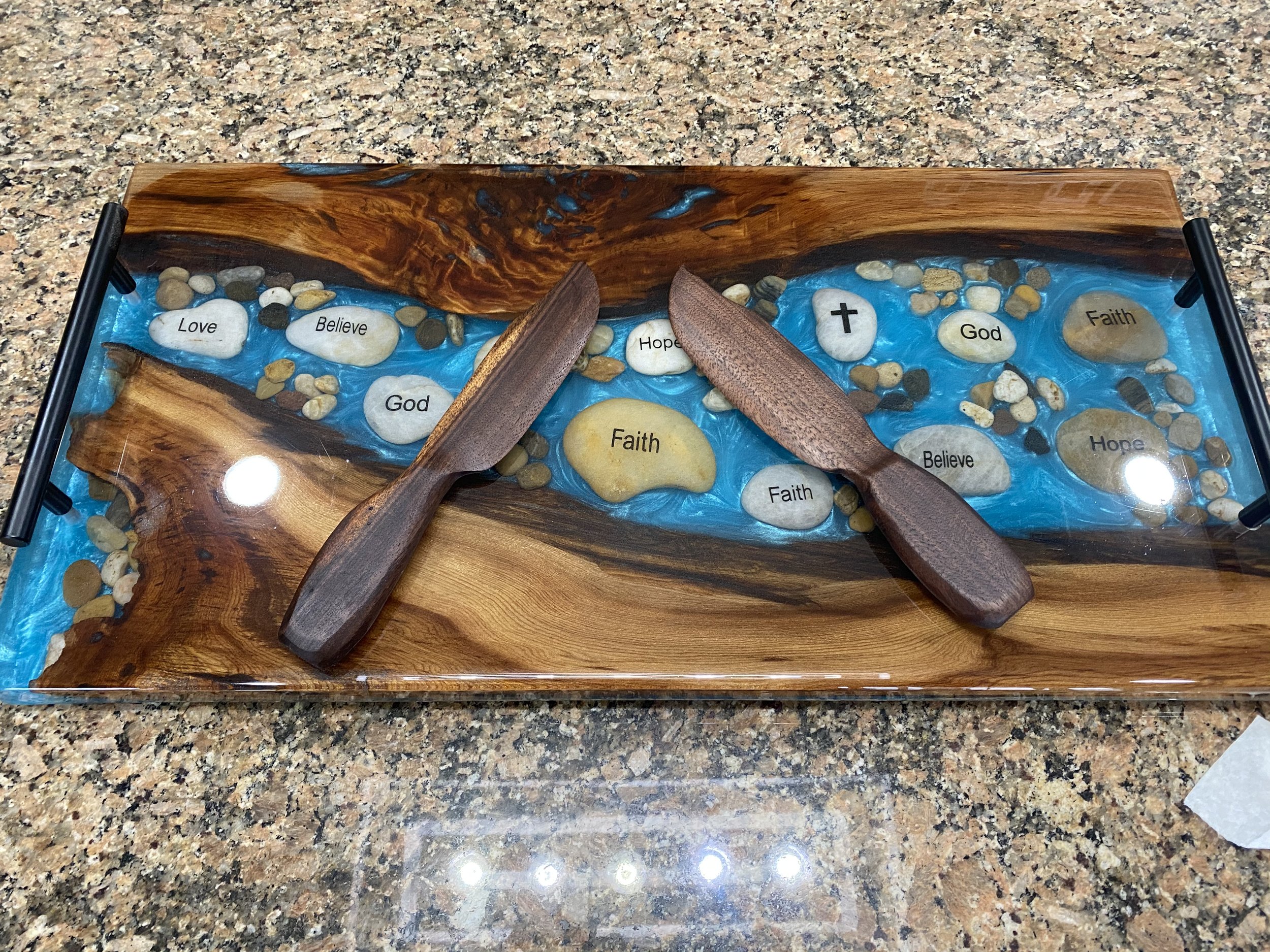 sinker cypress charcuterie board with blue epoxy and faith rocks
