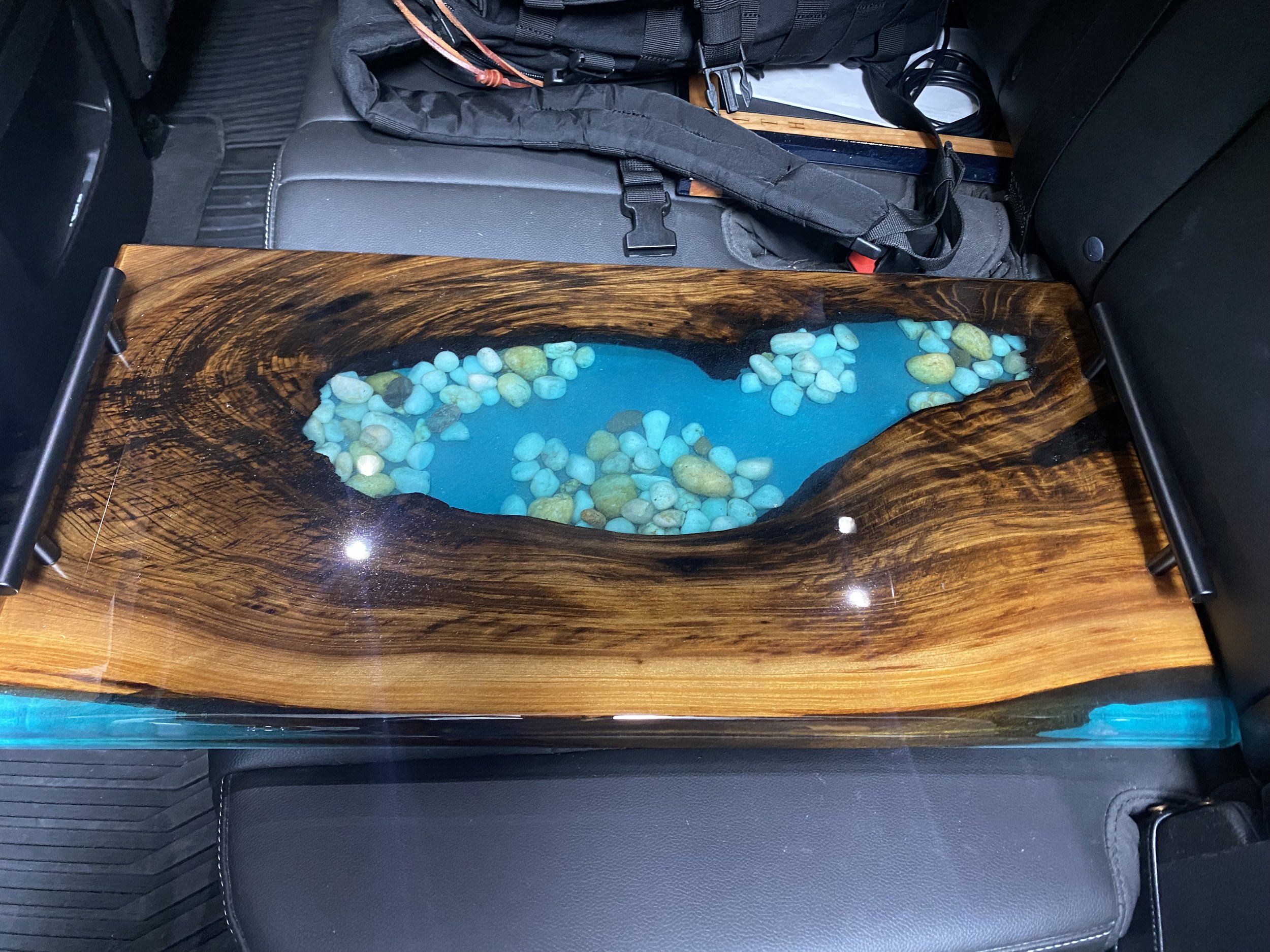 sinker cypress charcuterie board with blue epoxy and rocks