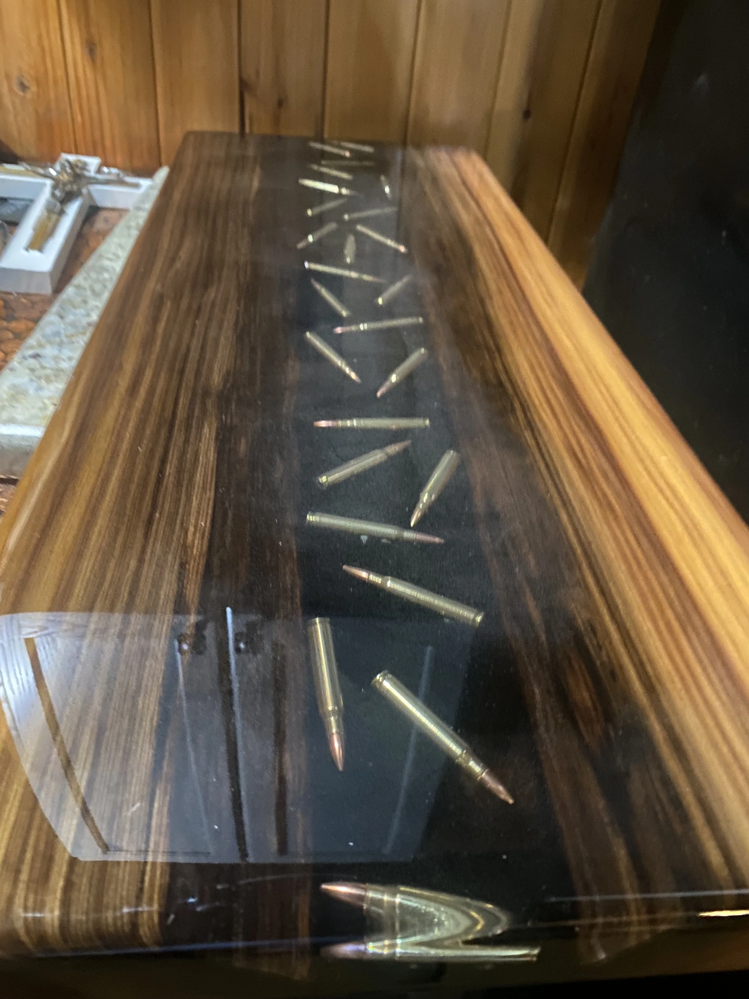cypress chacuterie board with clear epoxy containing bullets